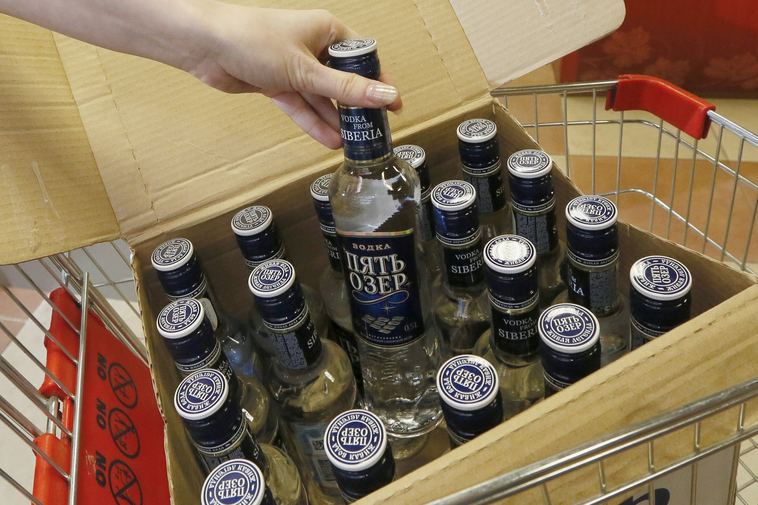 Vodka bottle being picked out from a box