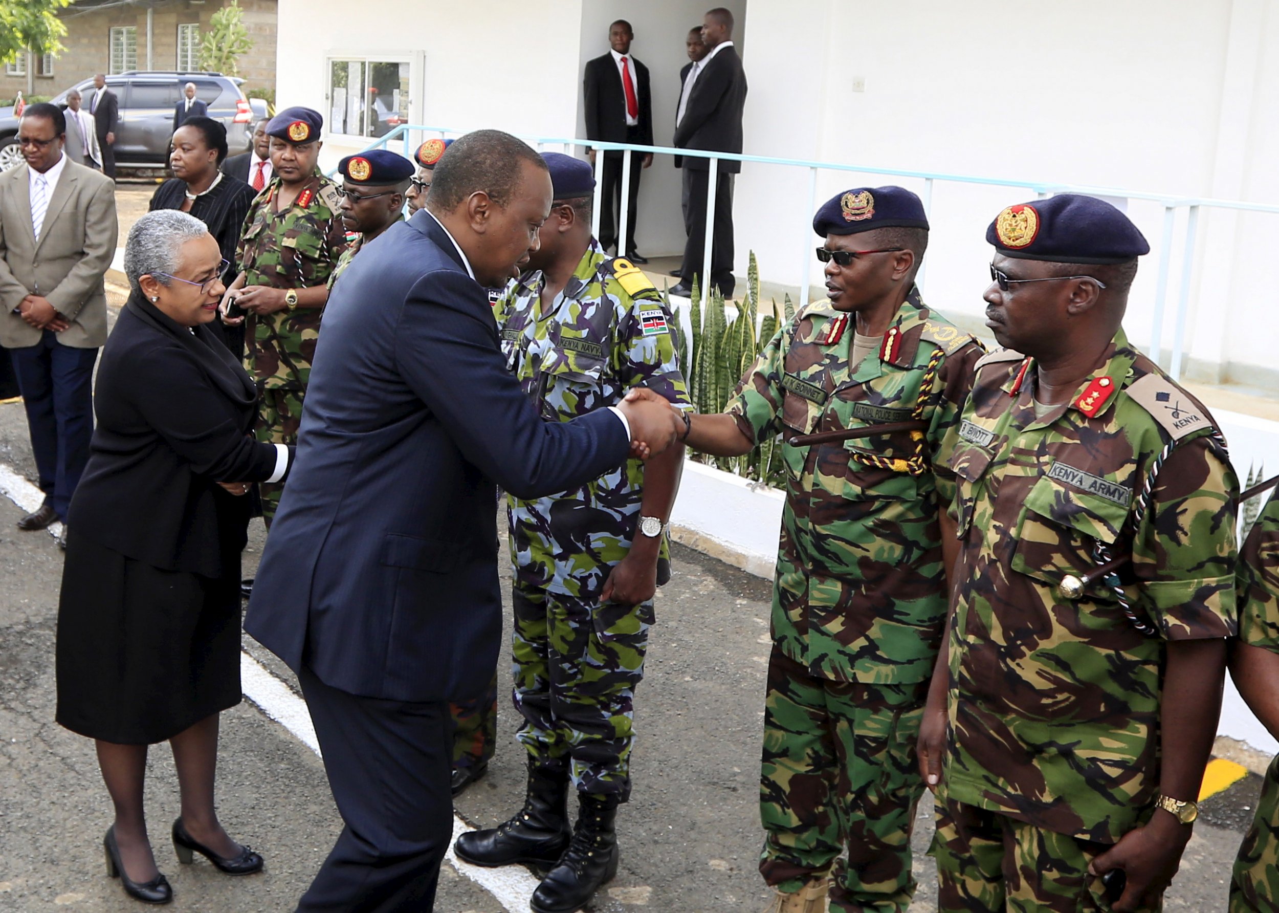 Uhuru Kenyatta greets military officers after Al-Shabab attack.