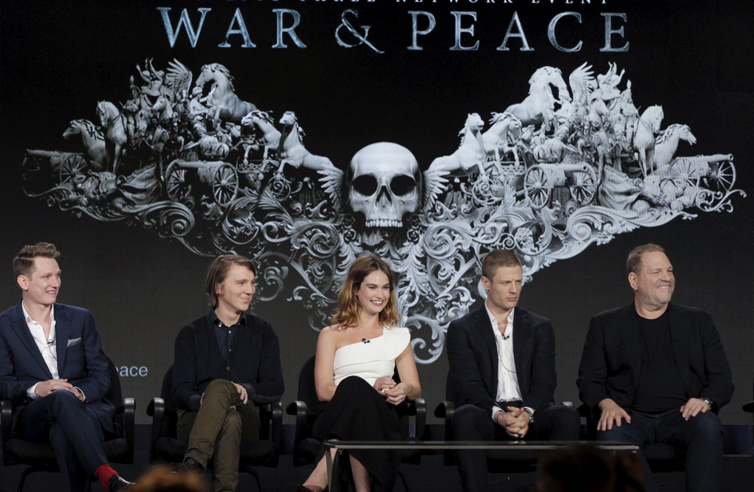 War and Peace cast sit in front of show title card