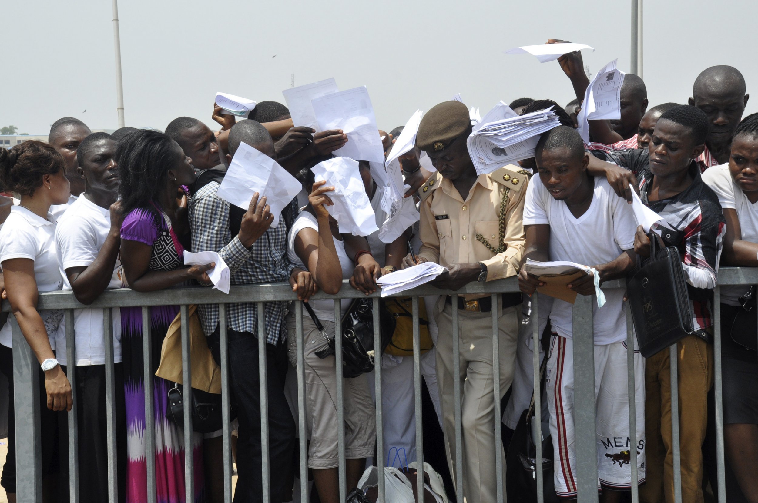 Nigerians try to submit applications at the Nigerian Immigration Service recruitment drive in Abuja.