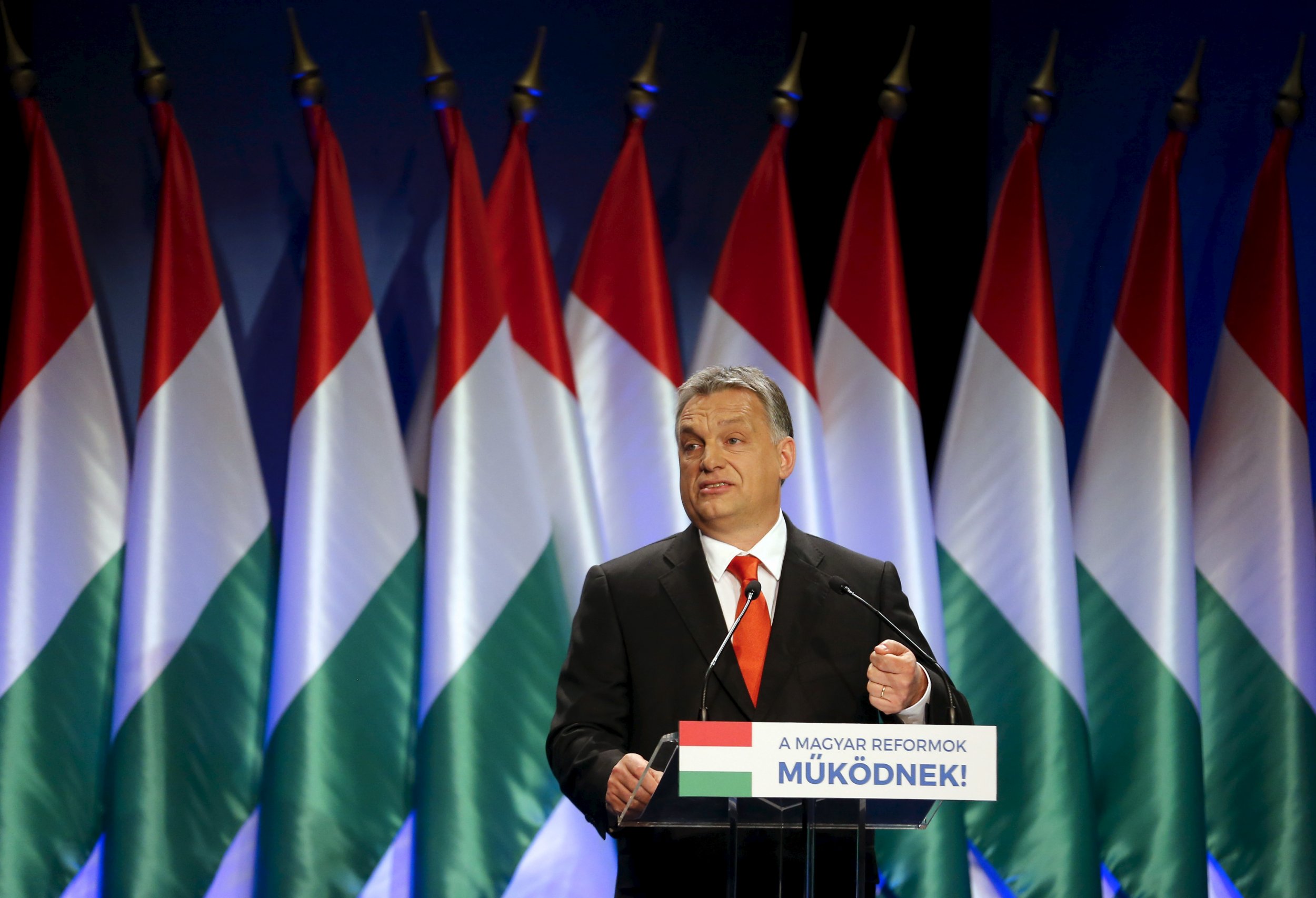 Viktor Orban speaks in front of Hungarian flags