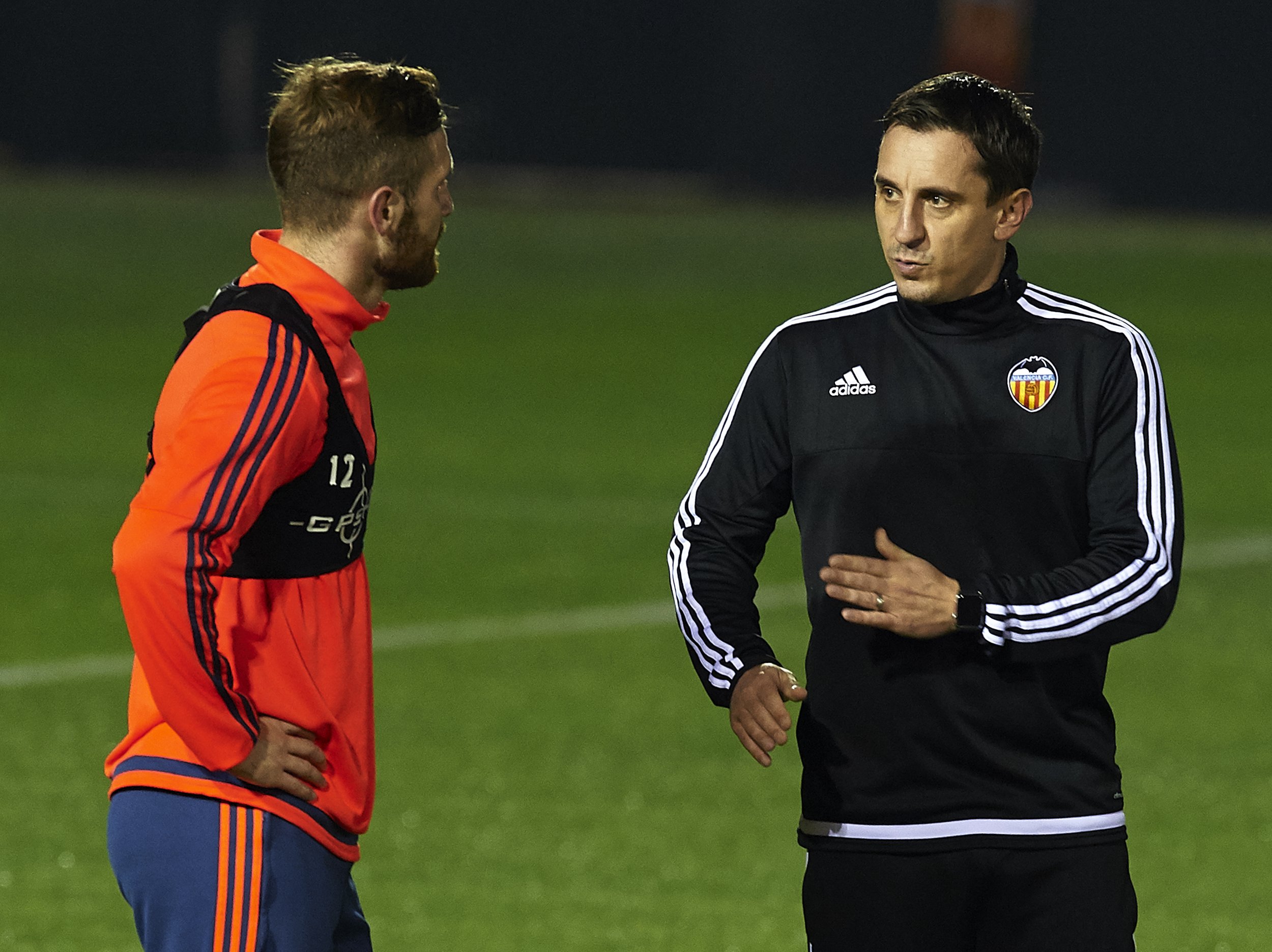 Gary Neville, right, talks to Shkodran Mustafi 