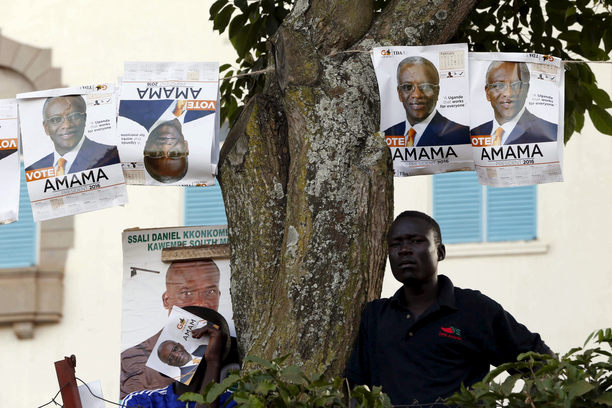 An Amama Mbabazi supporter rests during a campaign rally.