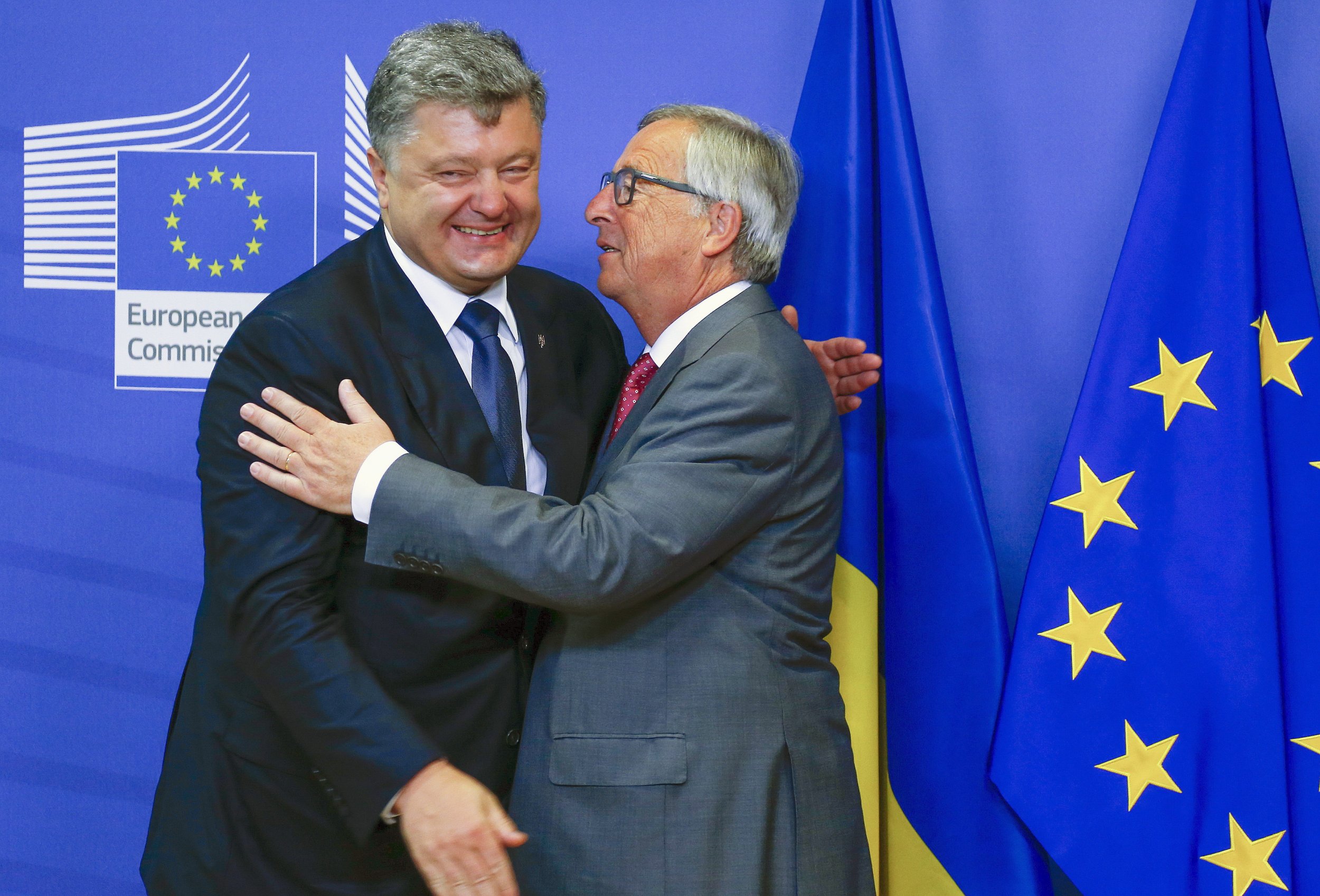 Poroshenko and Juncker hug