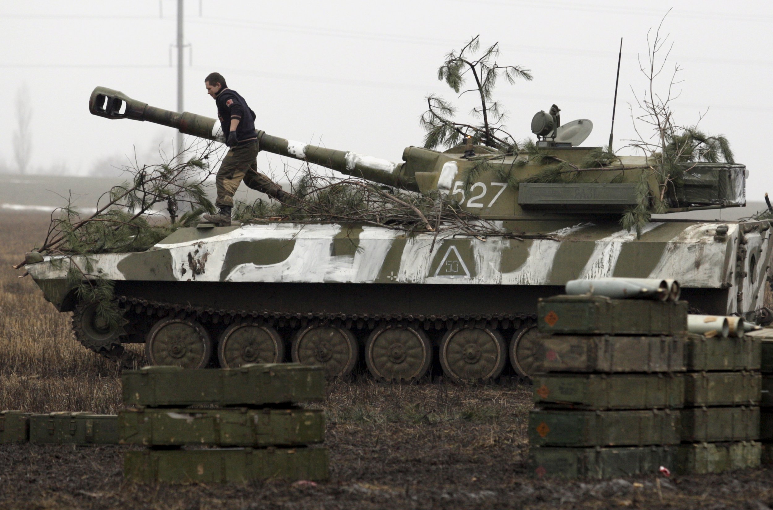 pro-Russian rebel walks on tank 