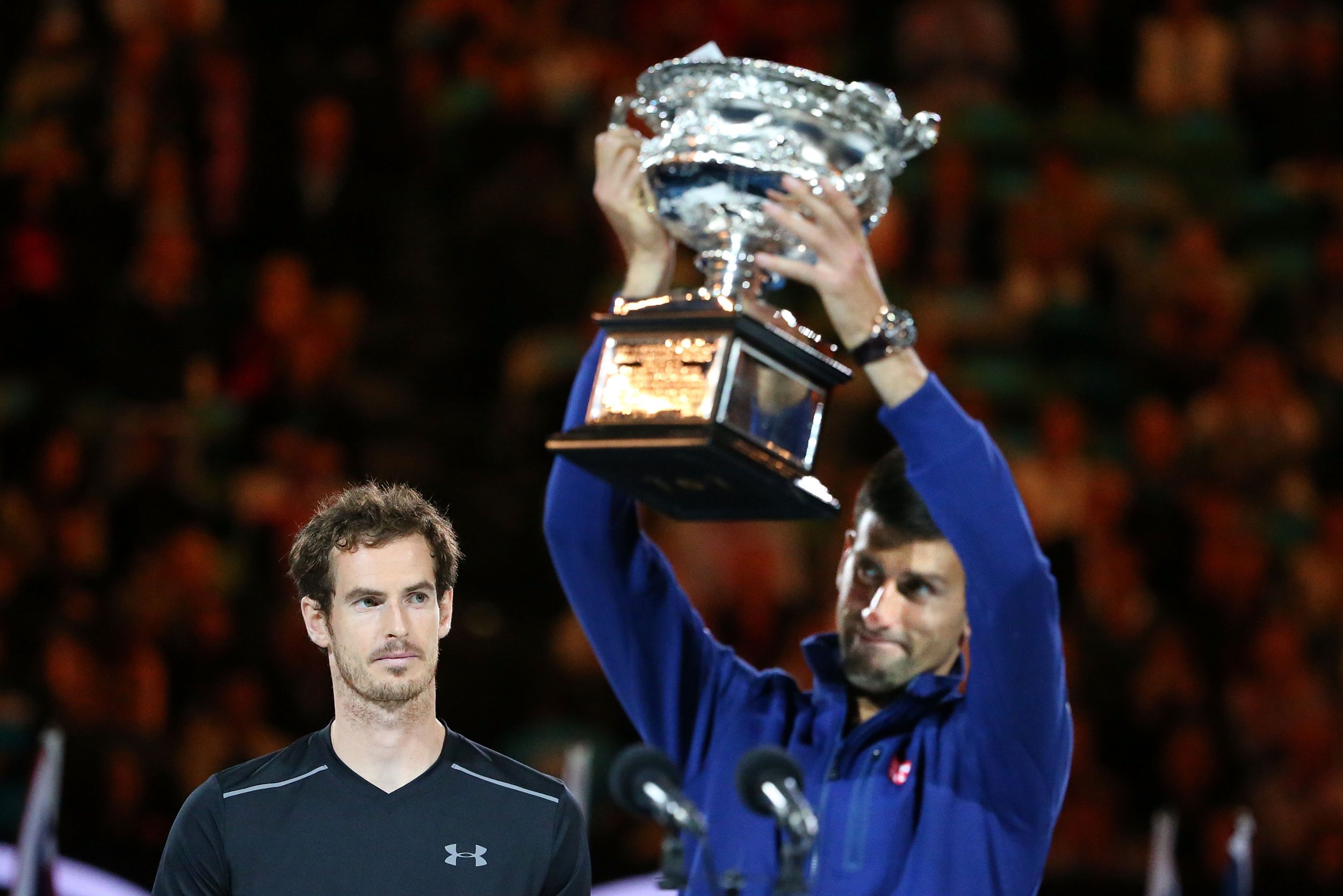 Novak Djokovic lifts the 2016 Australian Open trophy after beating Britain's Andy Murray.