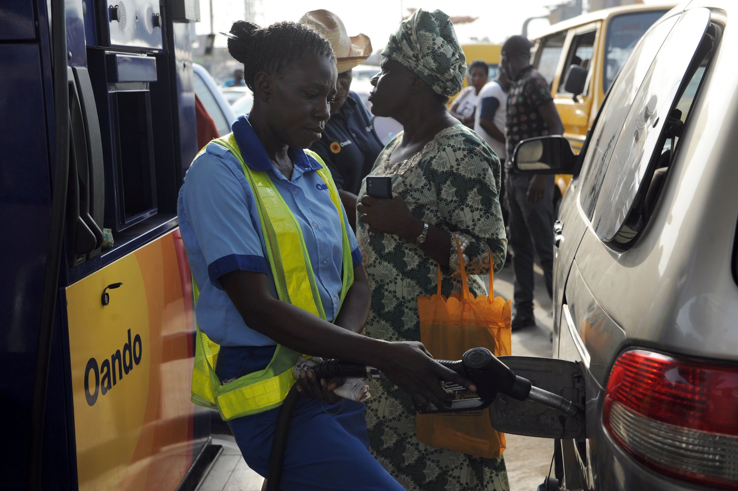 A Nigerian gas attendant fills a vehicle in Lagos.