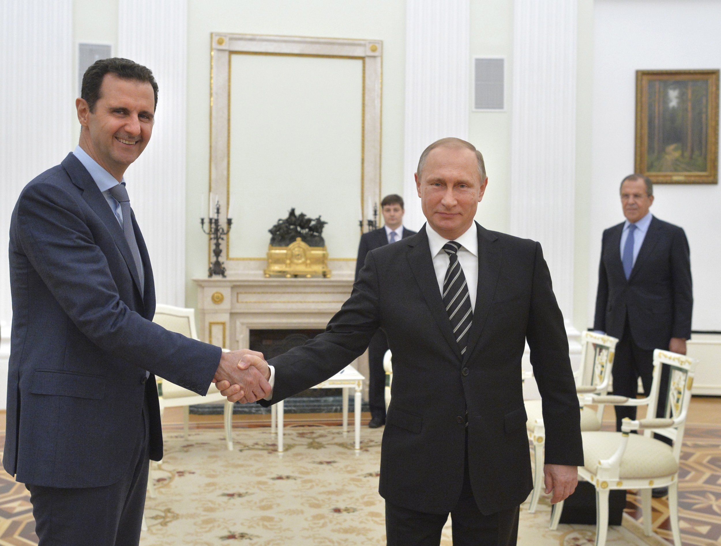 Putin and Assad shake hands