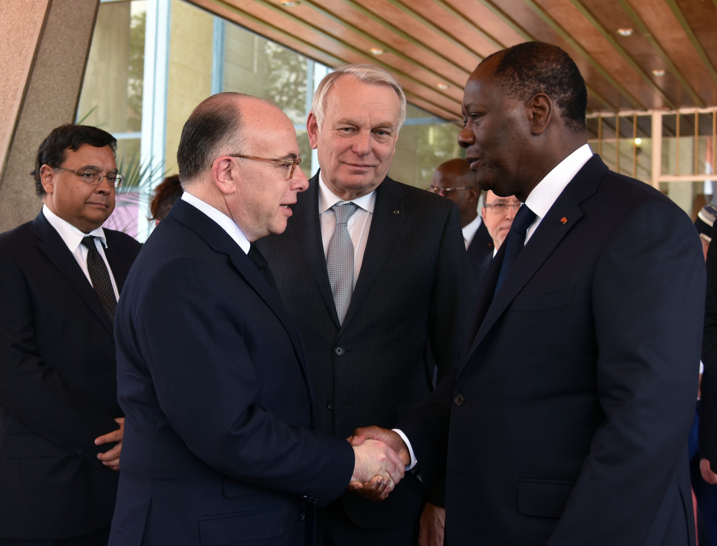 French interior minister Bernard Cazeneuve greets Ivory Coast President Alassane Ouattara.