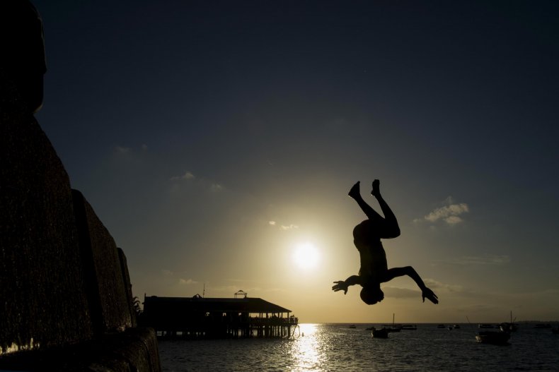 A youth jumps into the sea in Zanzibar.