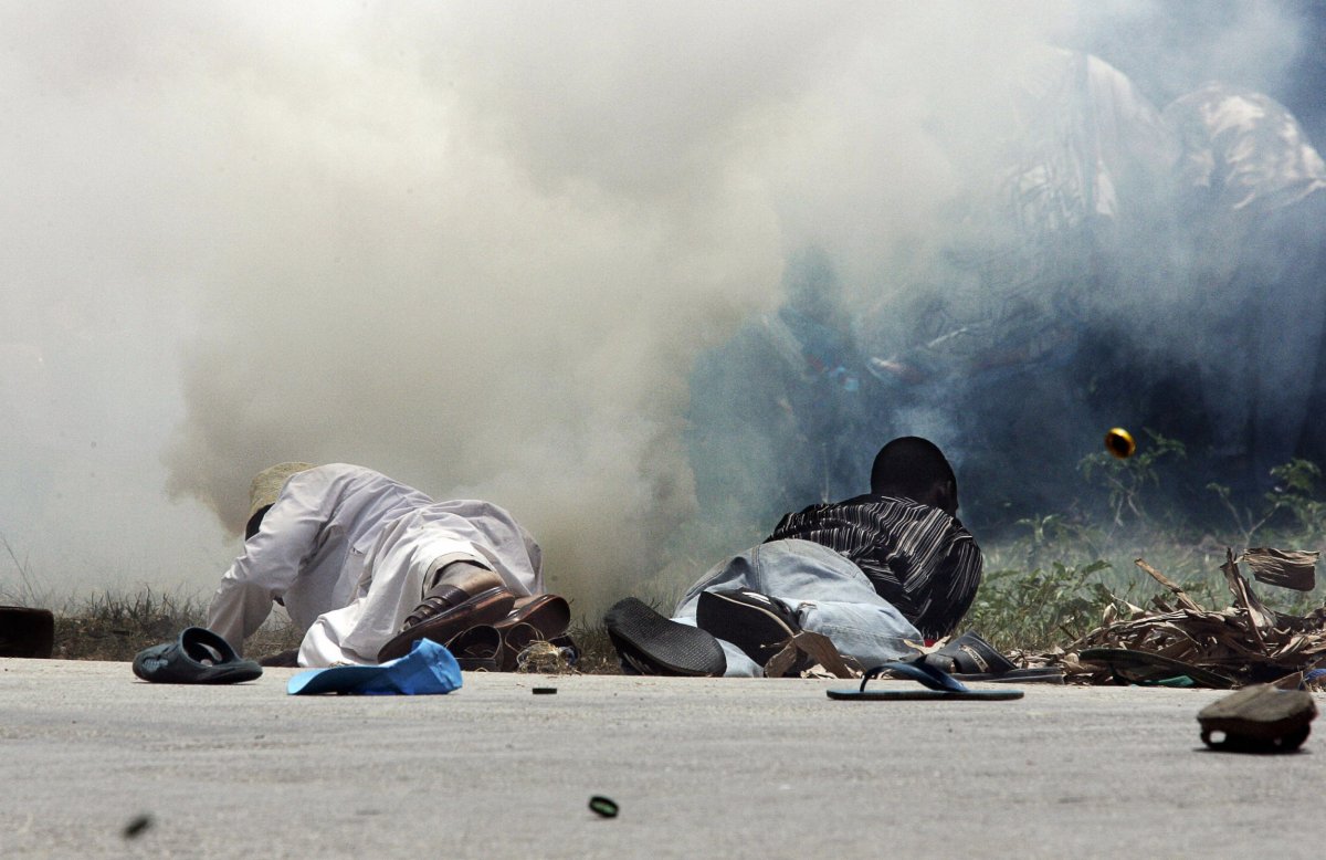 CUF supporters protect themselves from tear gas in Zanzibar.