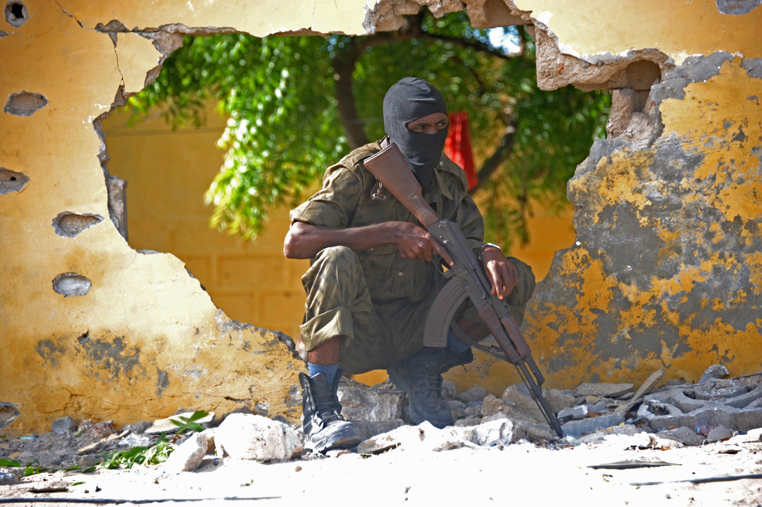 A Somali soldier stands guard after an Al-Shabab attack.