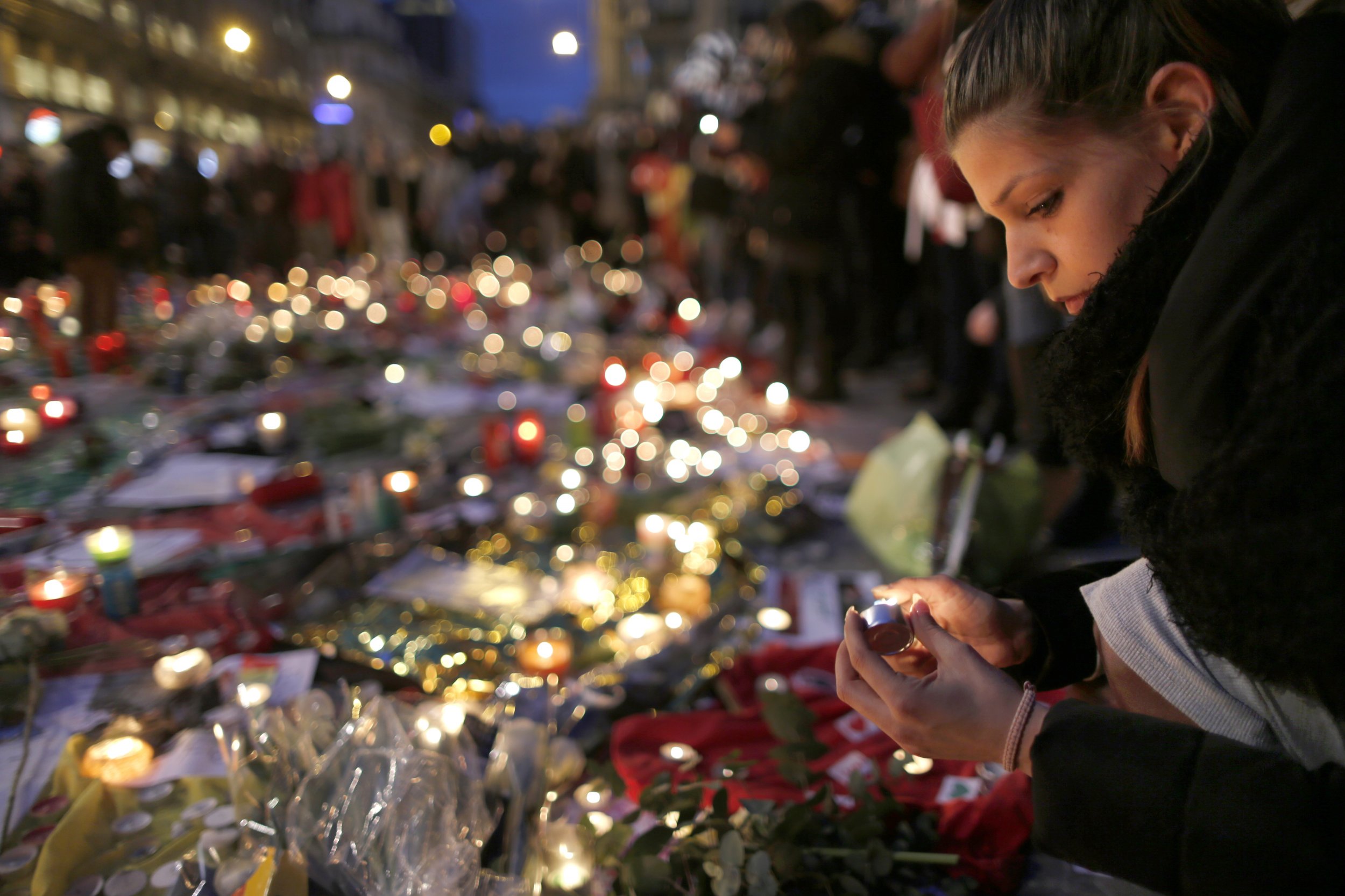 Woman attends street memorial for Brussels victims