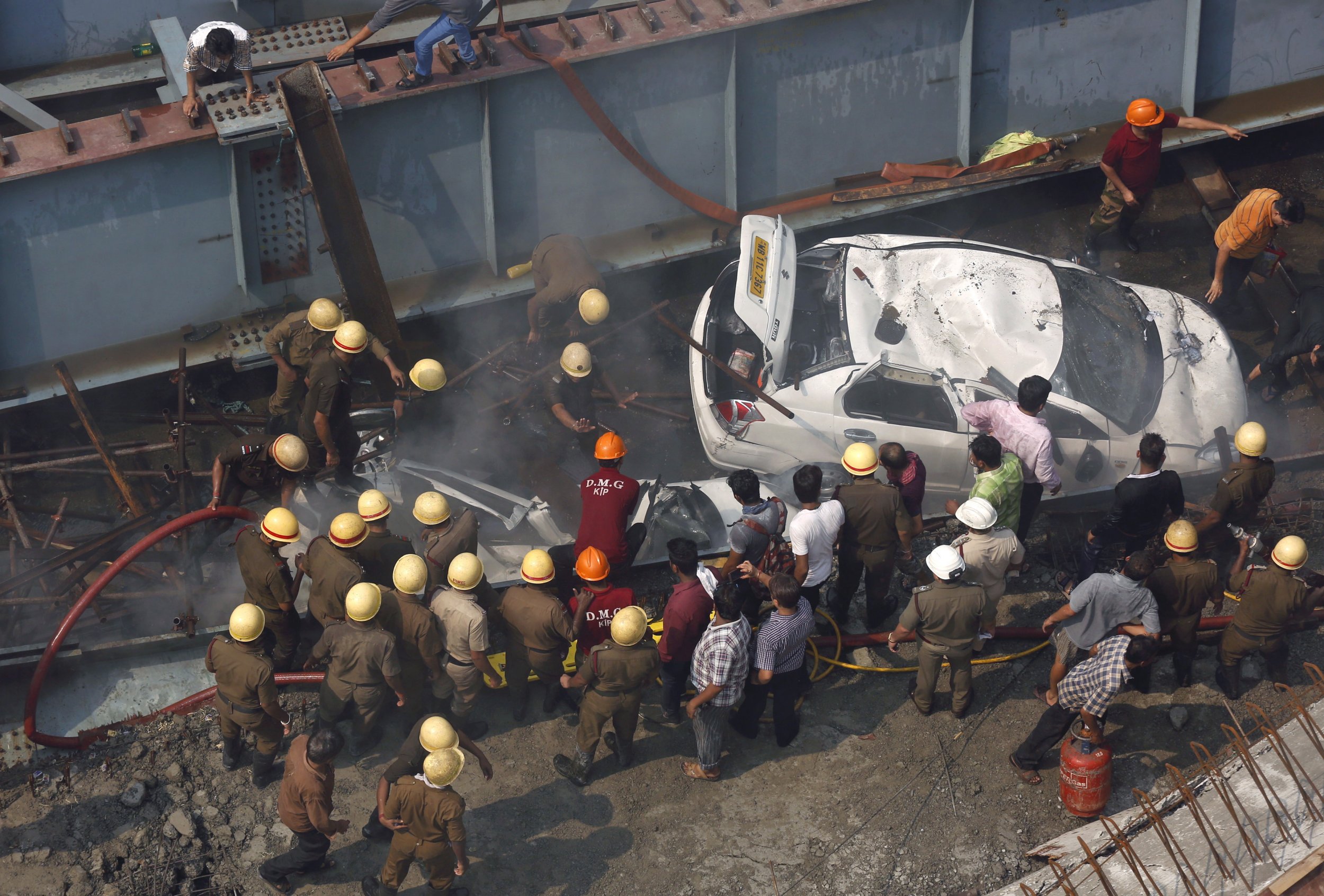 Rescue workers search for victims after India overpass collapses.