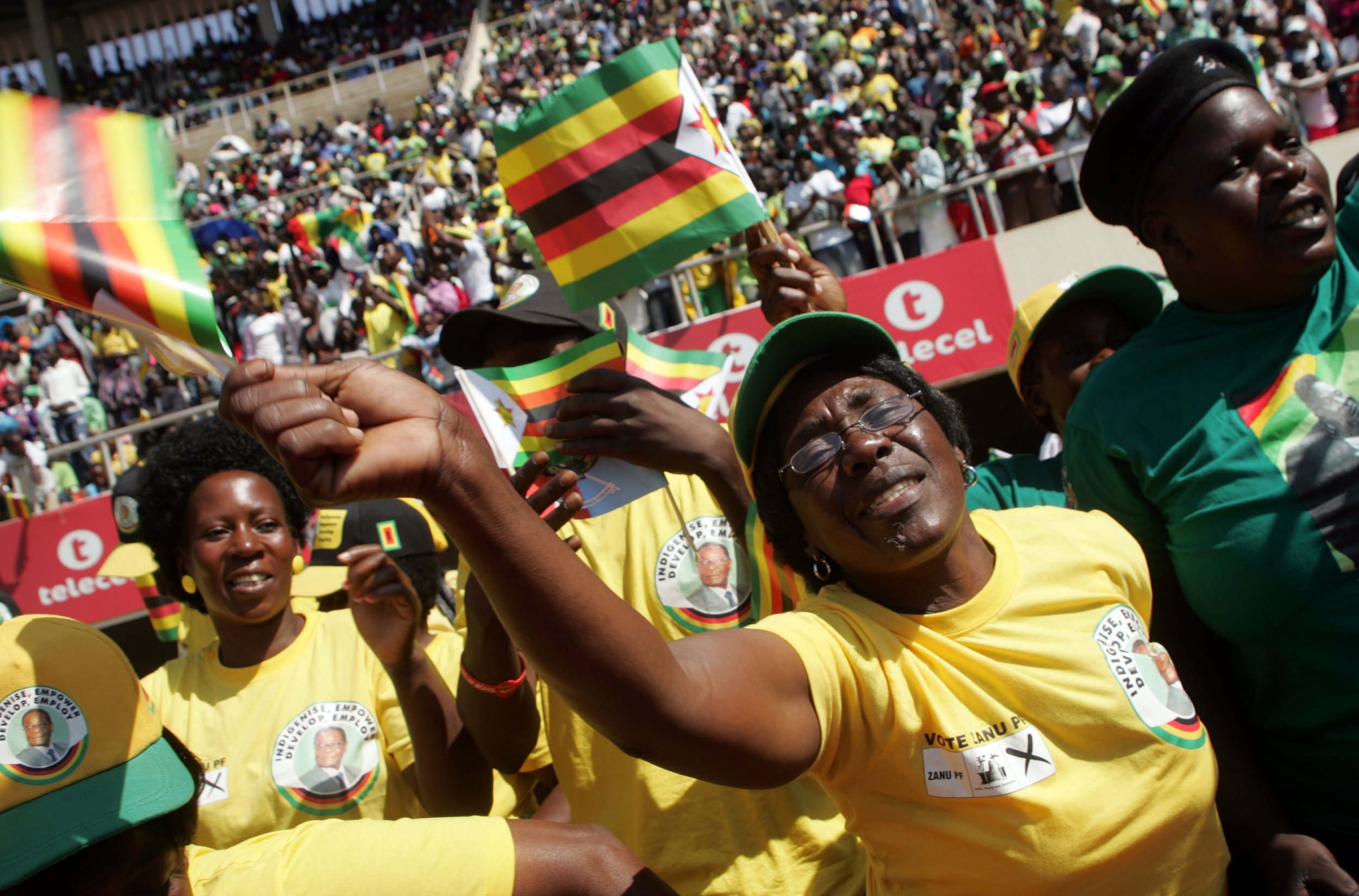 Supporters of Zimbabwe President Robert Mugabe cheer.