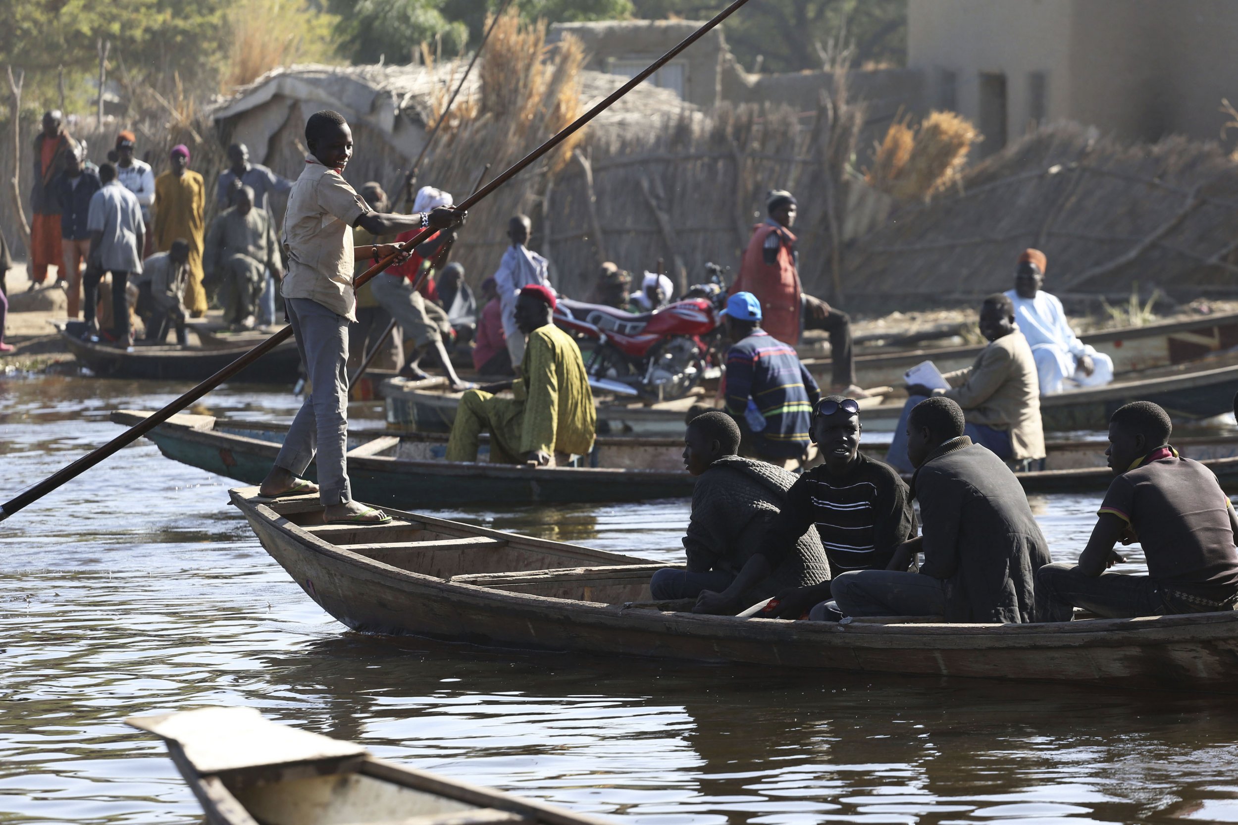 People cross Lake Chad.