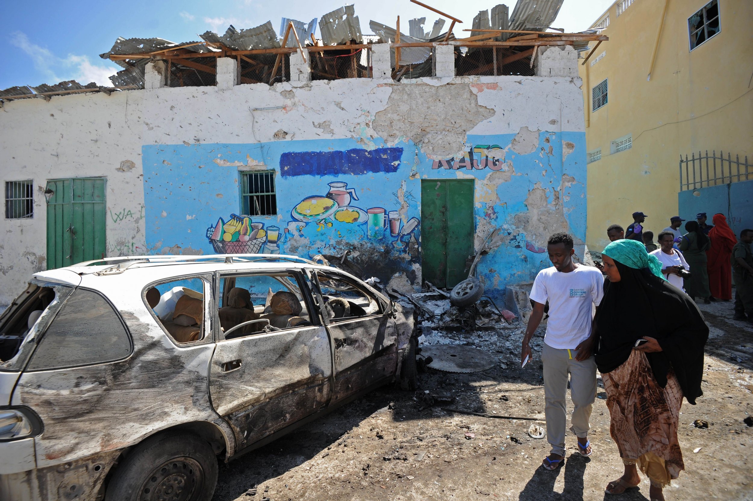 People view the wreckage of a car bomb in Mogadishu, Somalia.