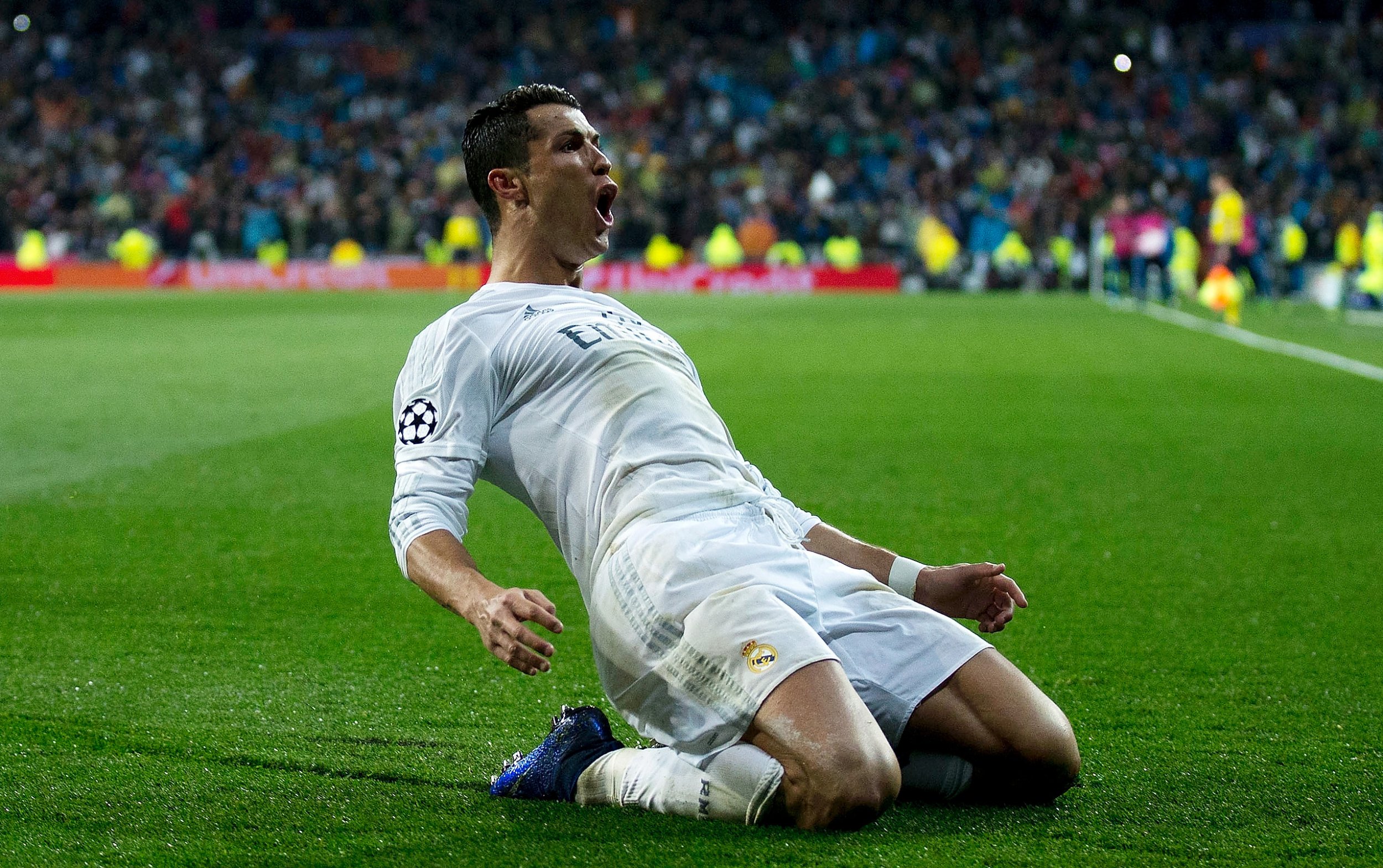  Cristiano Ronaldo is celebrating a goal while playing for Real Madrid, wearing his iconic white uniform.