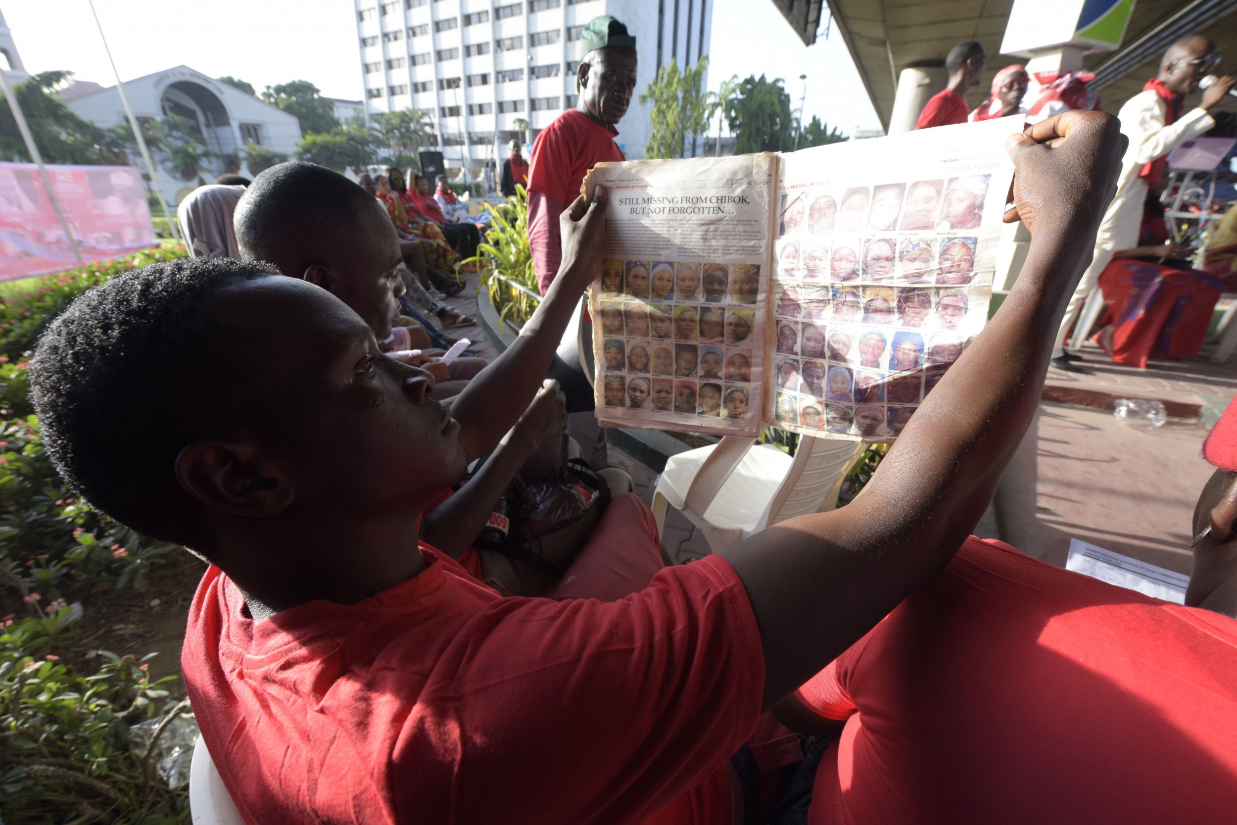 A man looks at pictures of the missing Chibok girls.