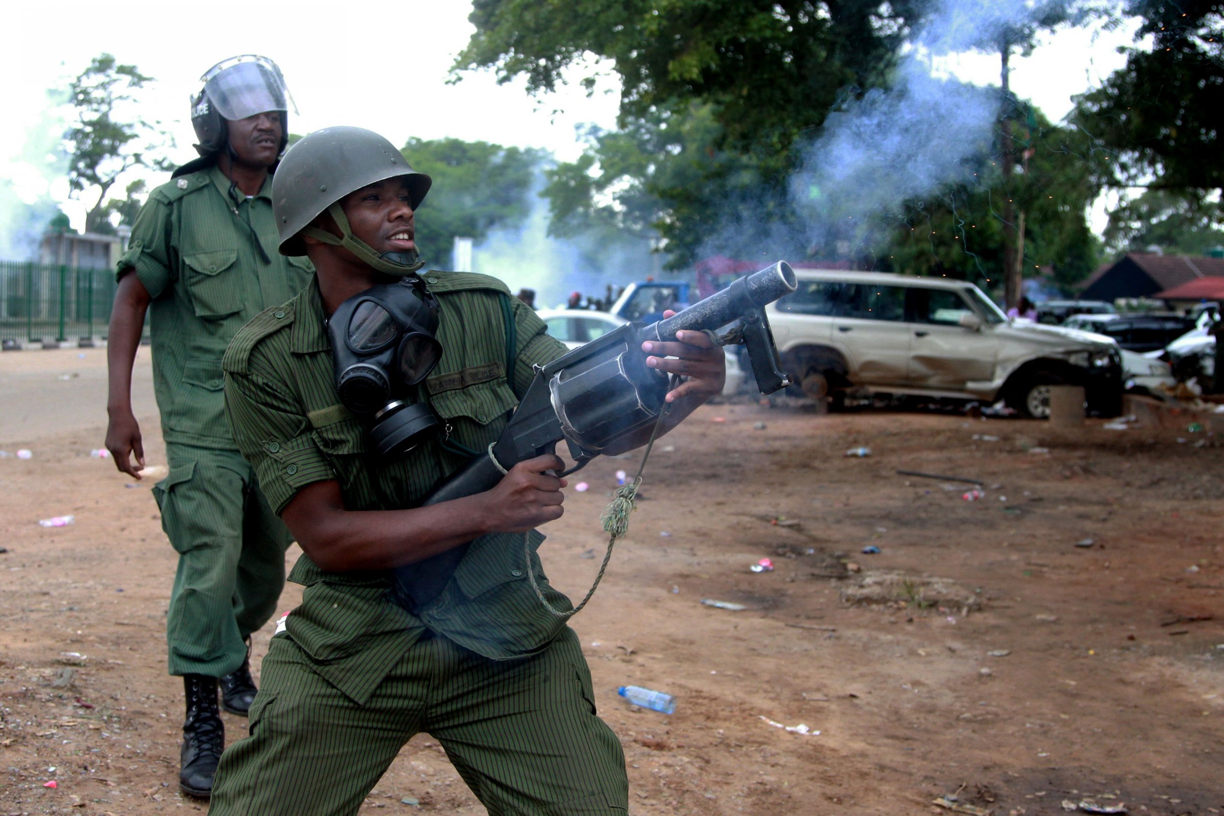 Zambian policeman fires tear gas in Lusaka.