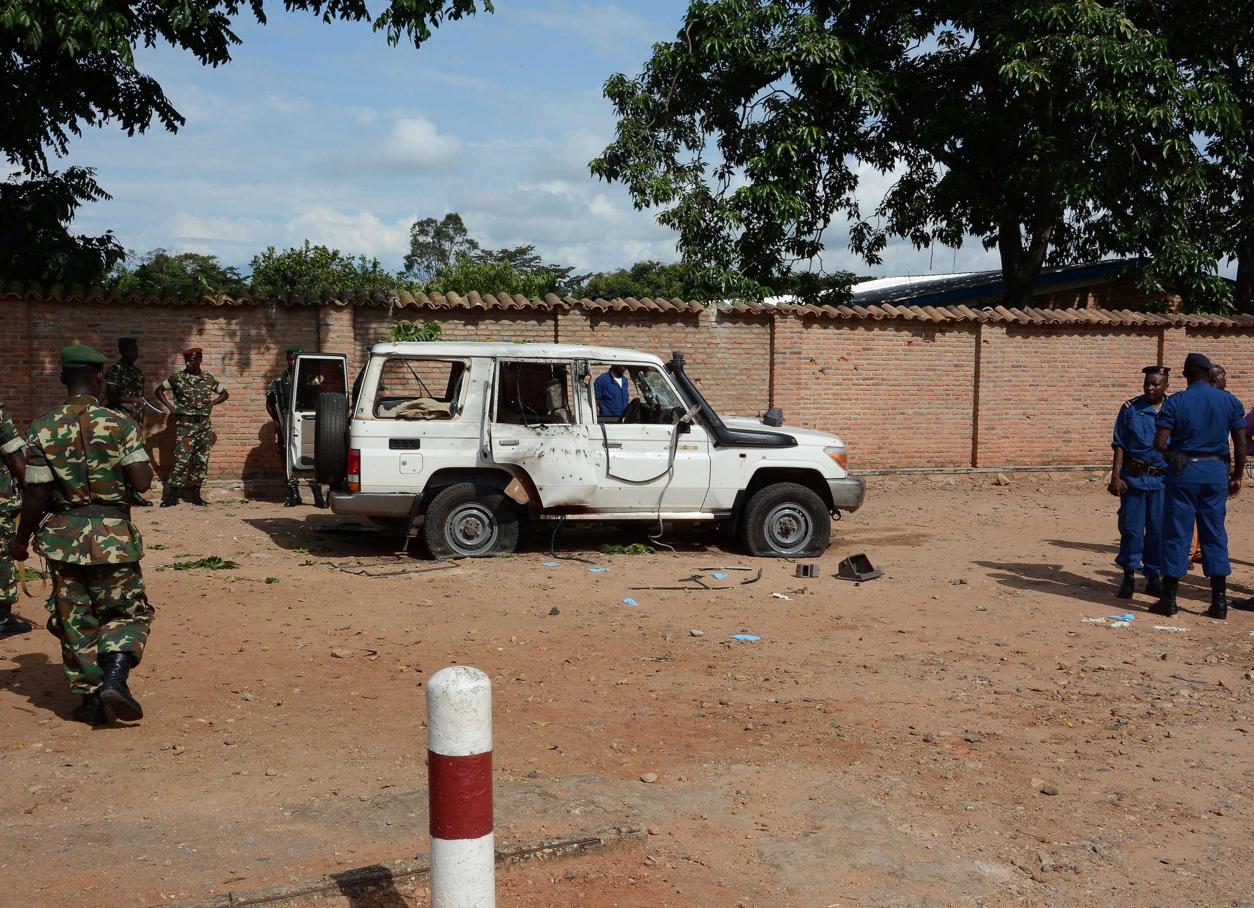 Burundian security officers at the scene of a killing