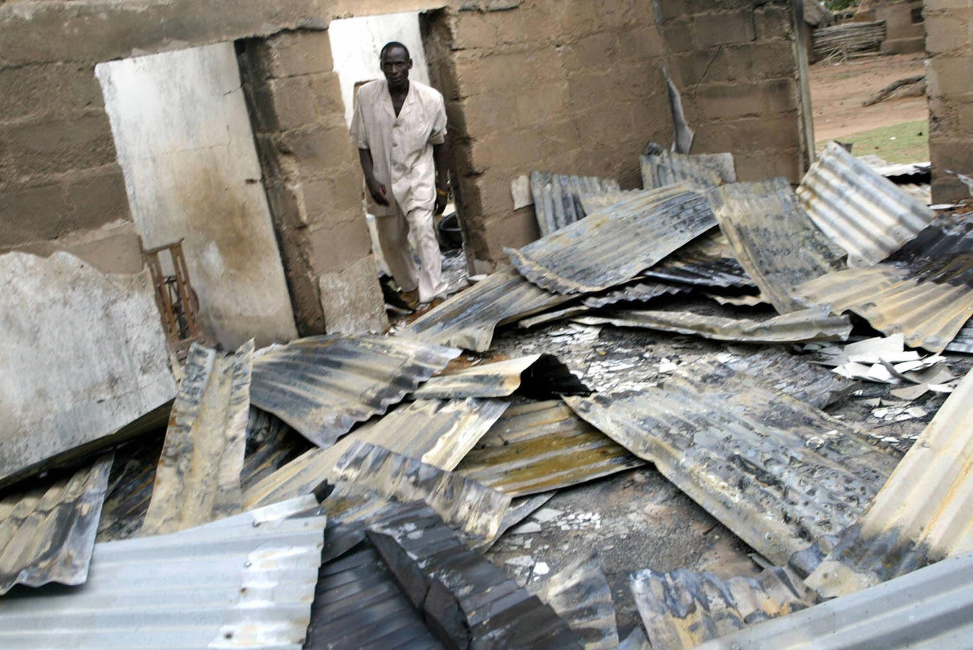 A pastor surveys a church destroyed by Fulani herdsmen in Plateau state.