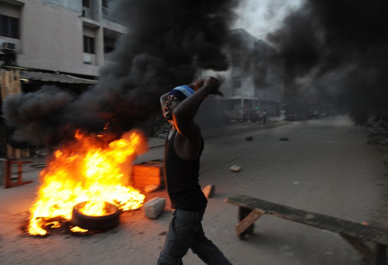 Ouattara supporter burns tyres after 2010 Ivory Coast election.