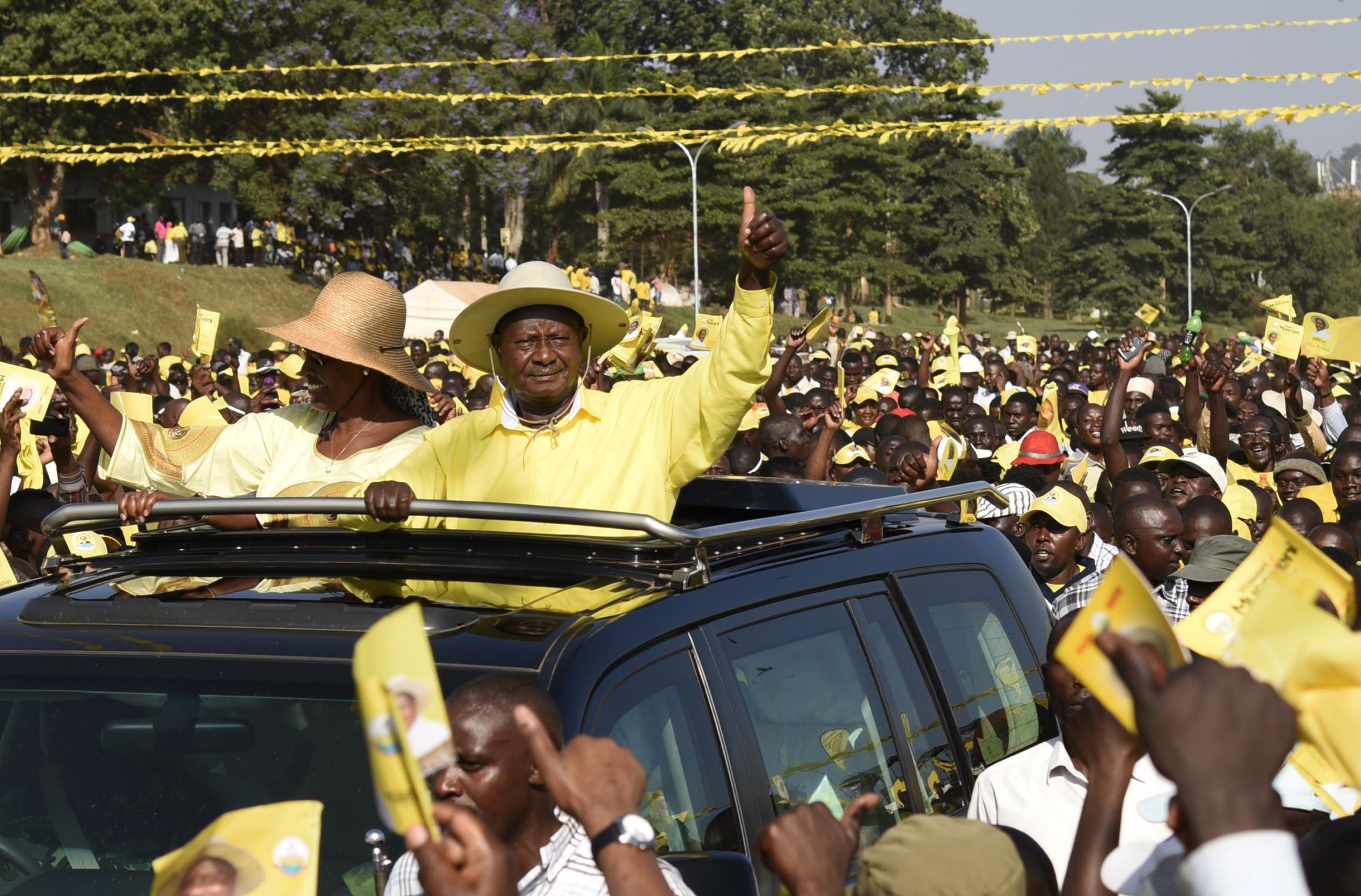 Yoweri and Janet Museveni wave to supporters.