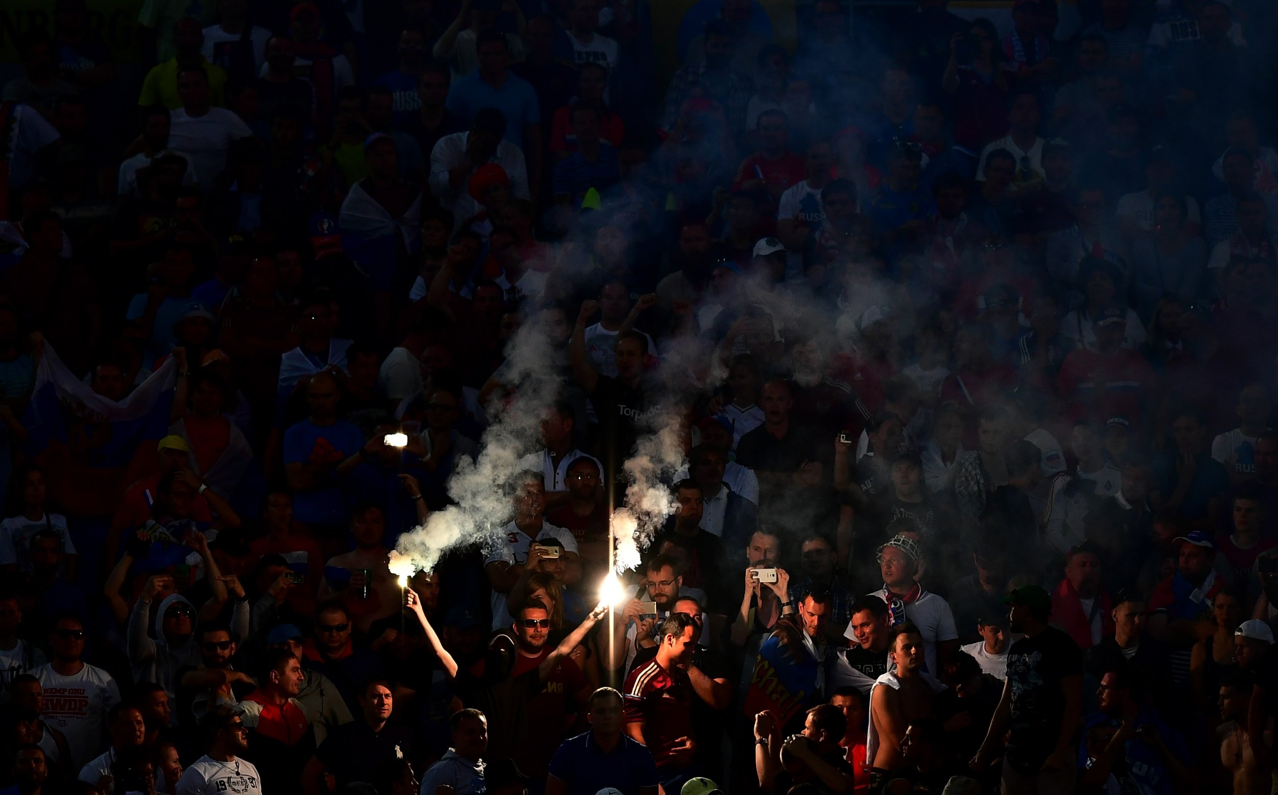 A Russian fan lights flares at Stade Velodrome.