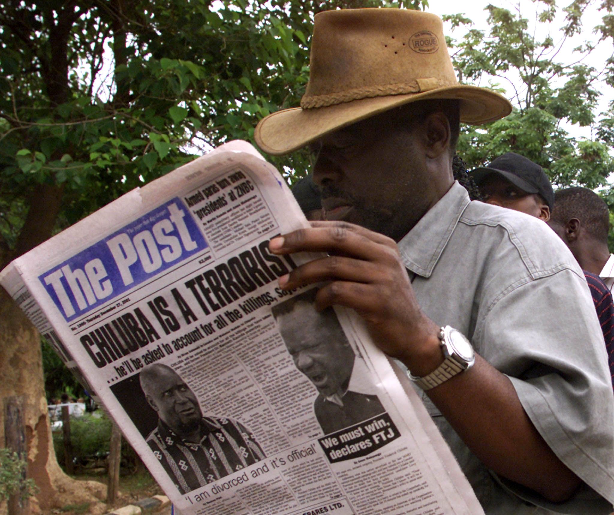 Zambian man reads The Post