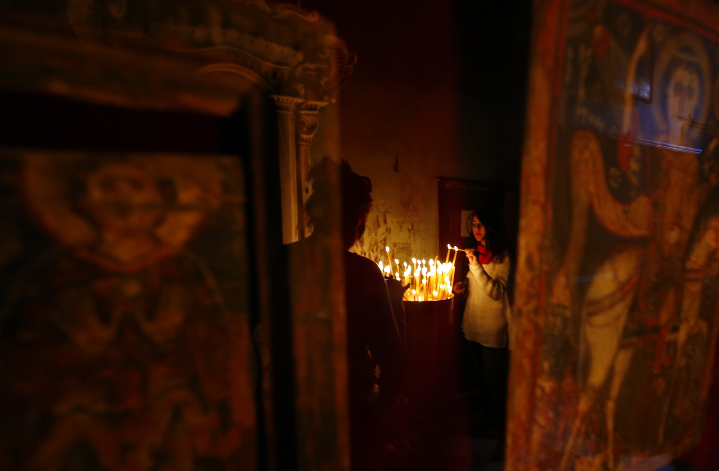 Christian lights candle in Sinai monastery