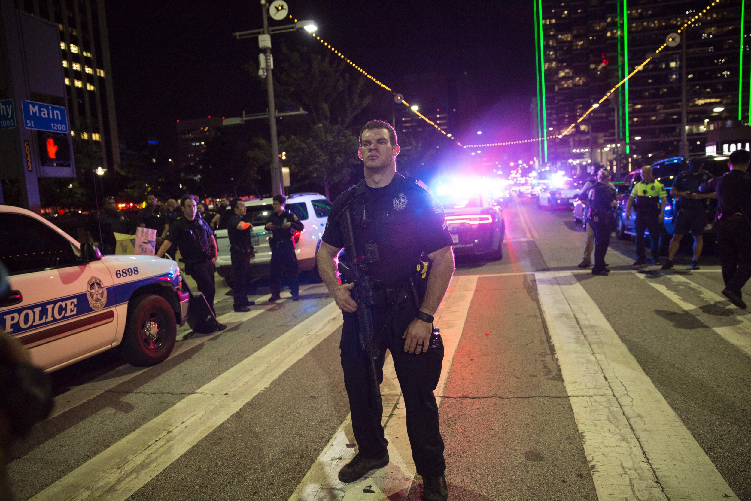 dallas news photo police officer and boy after shootings