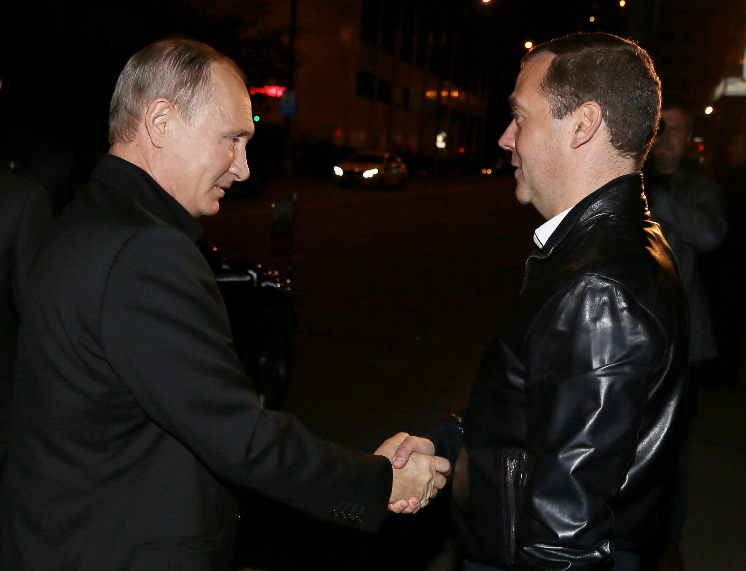 Vladimir Putin greets Dmitry Medvedev