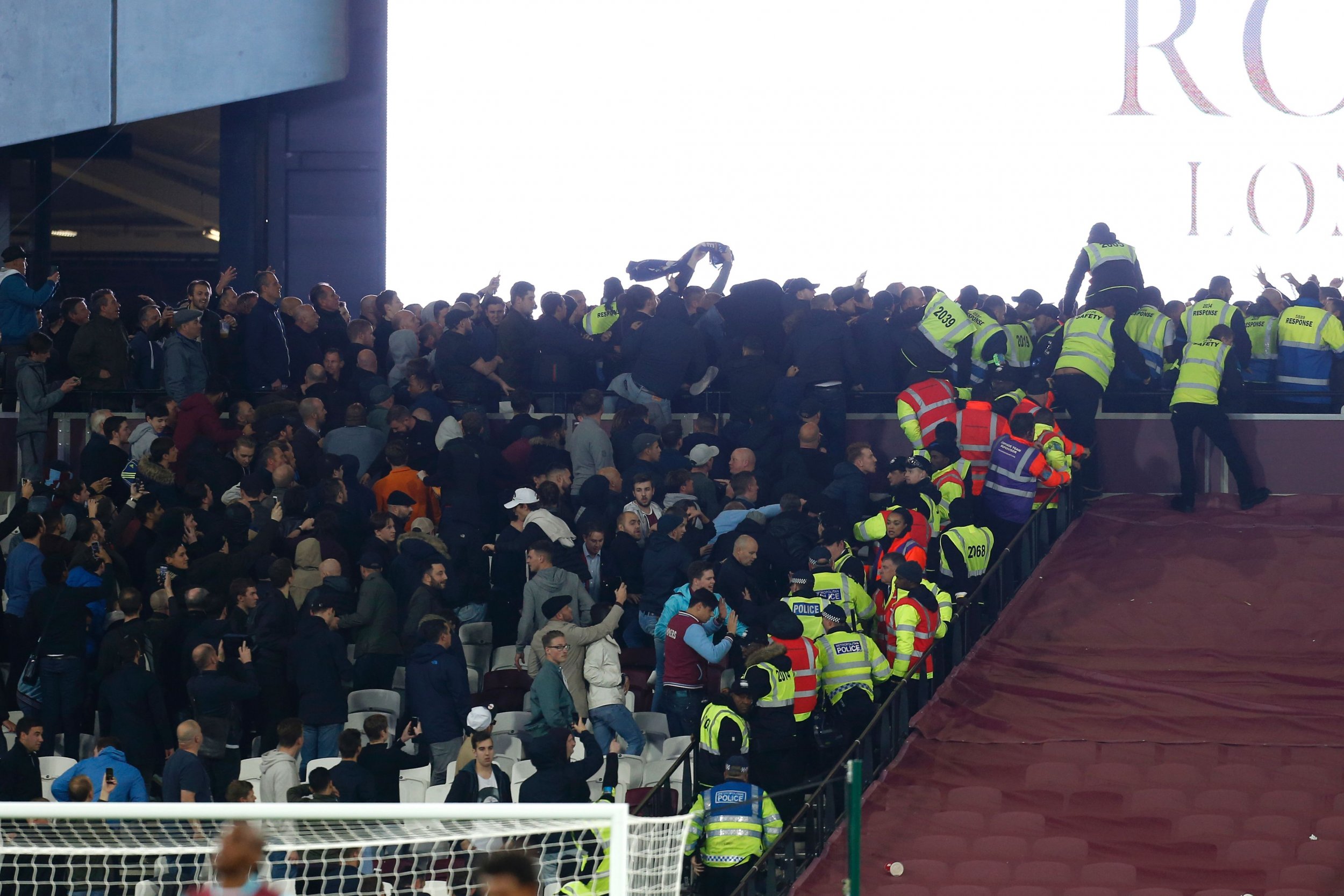 Police and stewards try to separate West Ham United and Chelsea supporters.