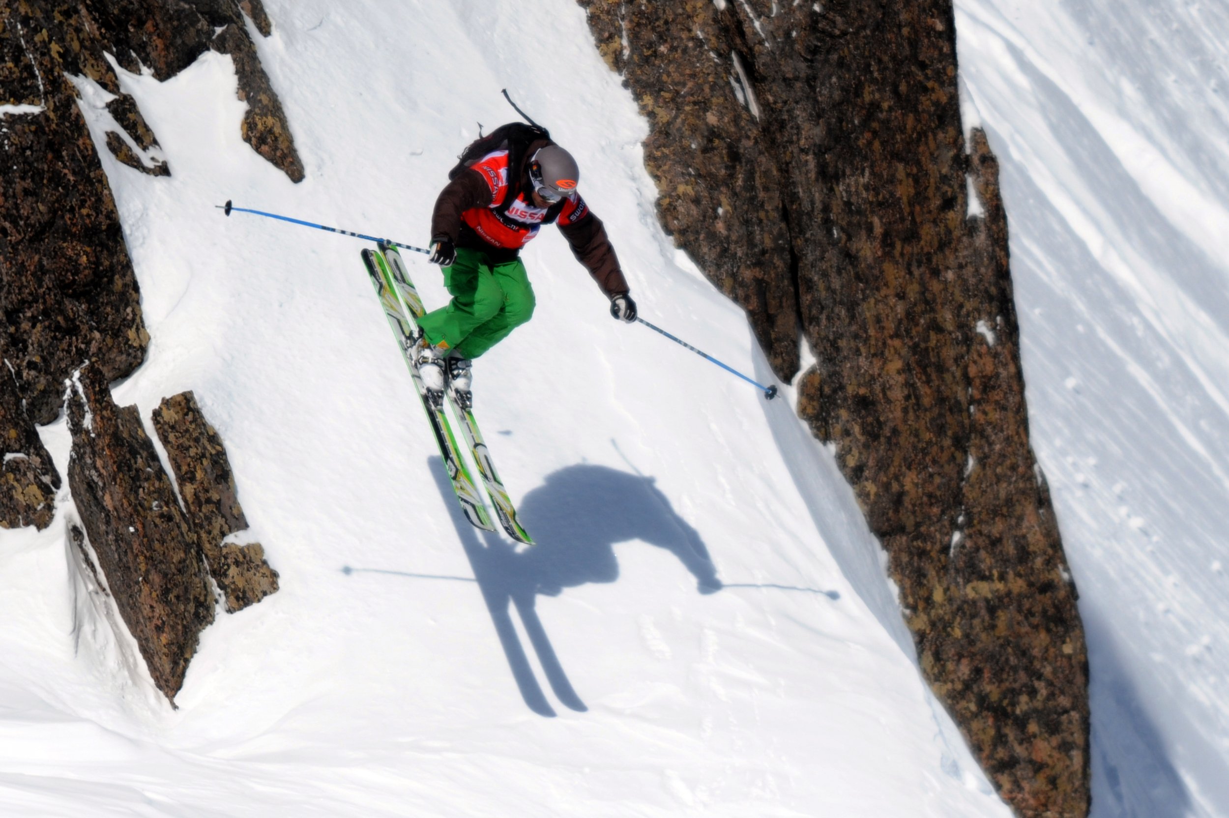 pro skier cliff jump, extreme skiing, winter mountain panorama