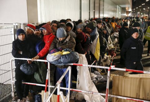 Refugees queue outside a Berlin registration office