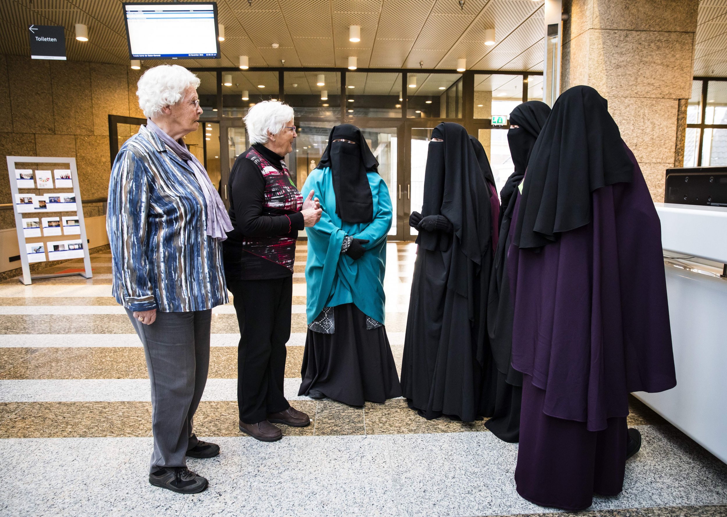 Women adorning the niqab attend the Dutch Senate