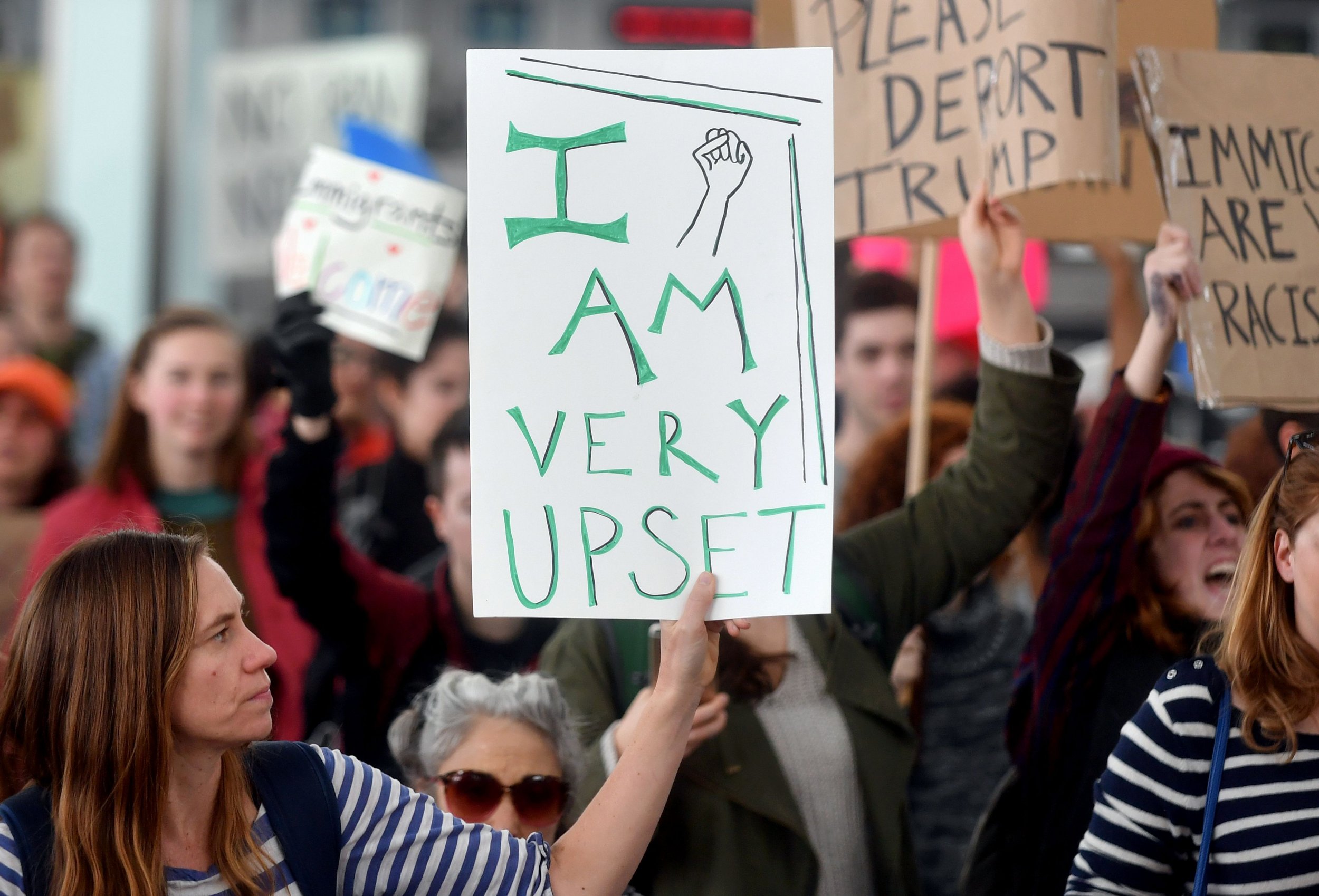 Protesters against Donald Trump's executive order hold up signs at San Francisco International Airport in San Francisco, California.