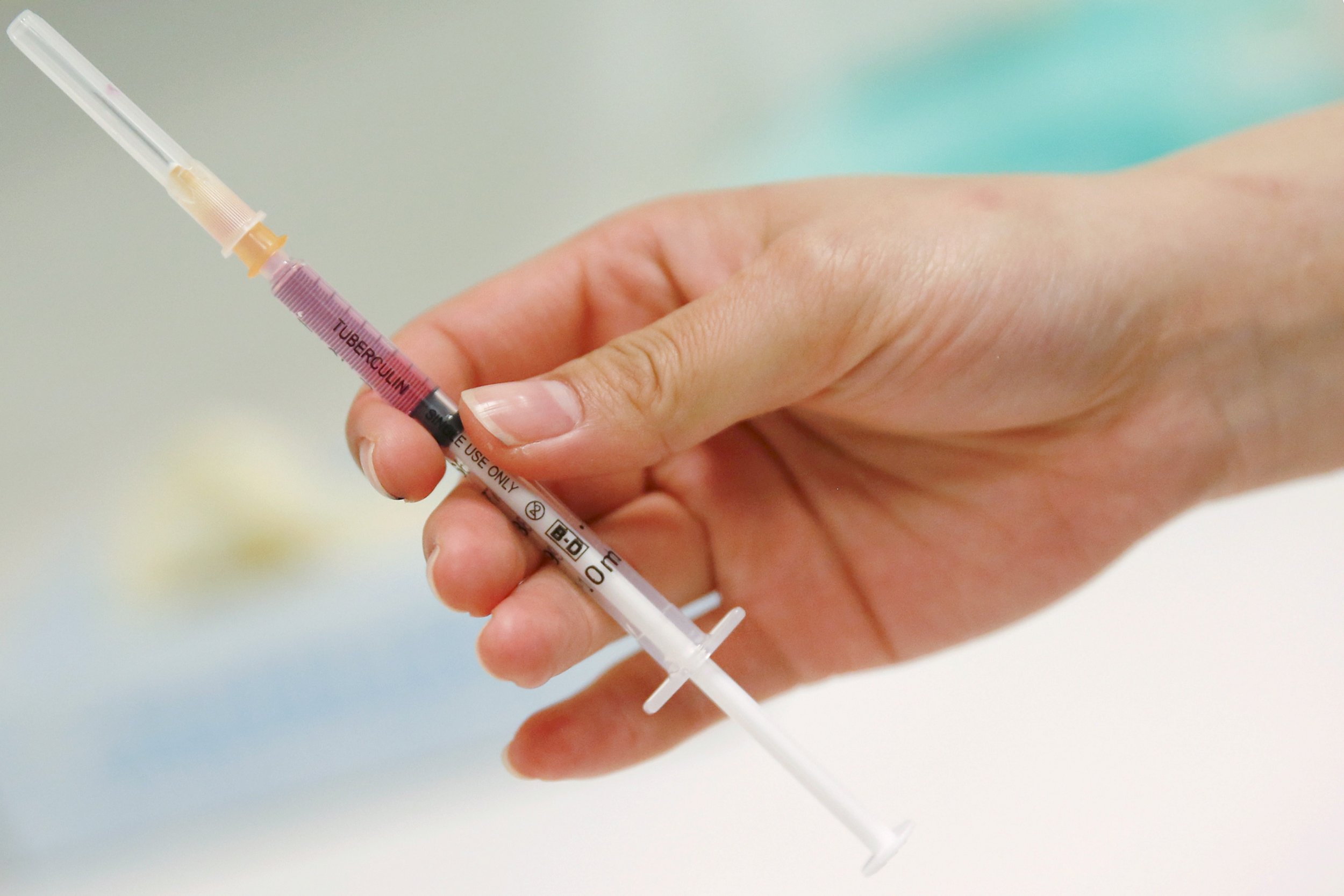 A nurse prepares a vaccine