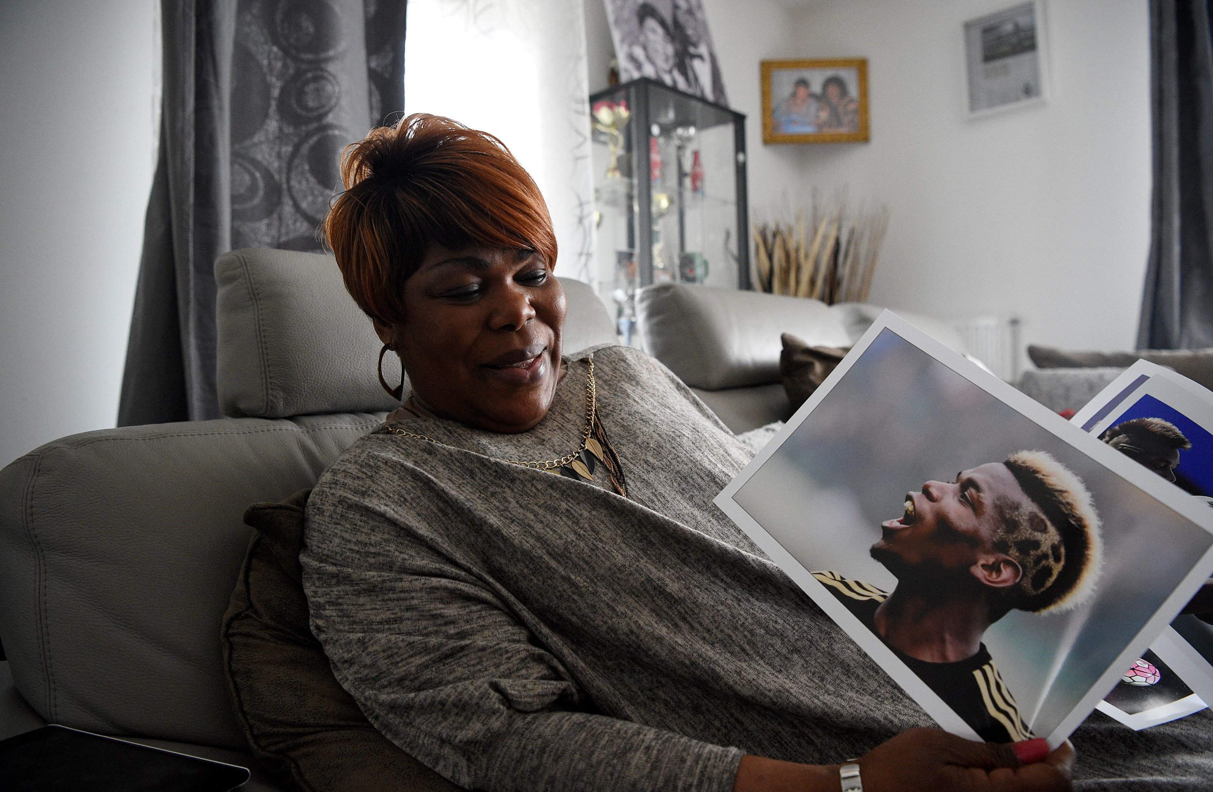 Yeo Moriba shows a picture of her son, Manchester United midfielder Paul.