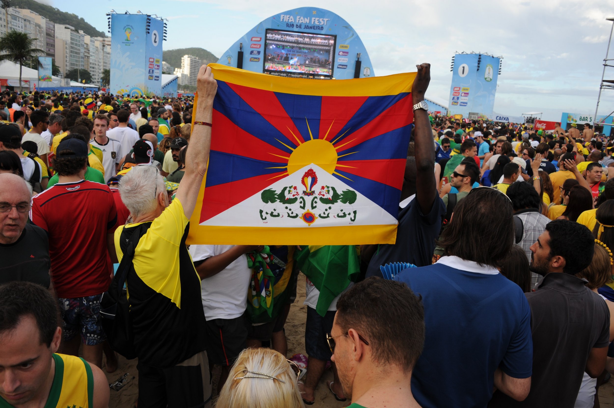 Supporters hold a Tibet flag at the Fan Fest in Rio de Janeiro