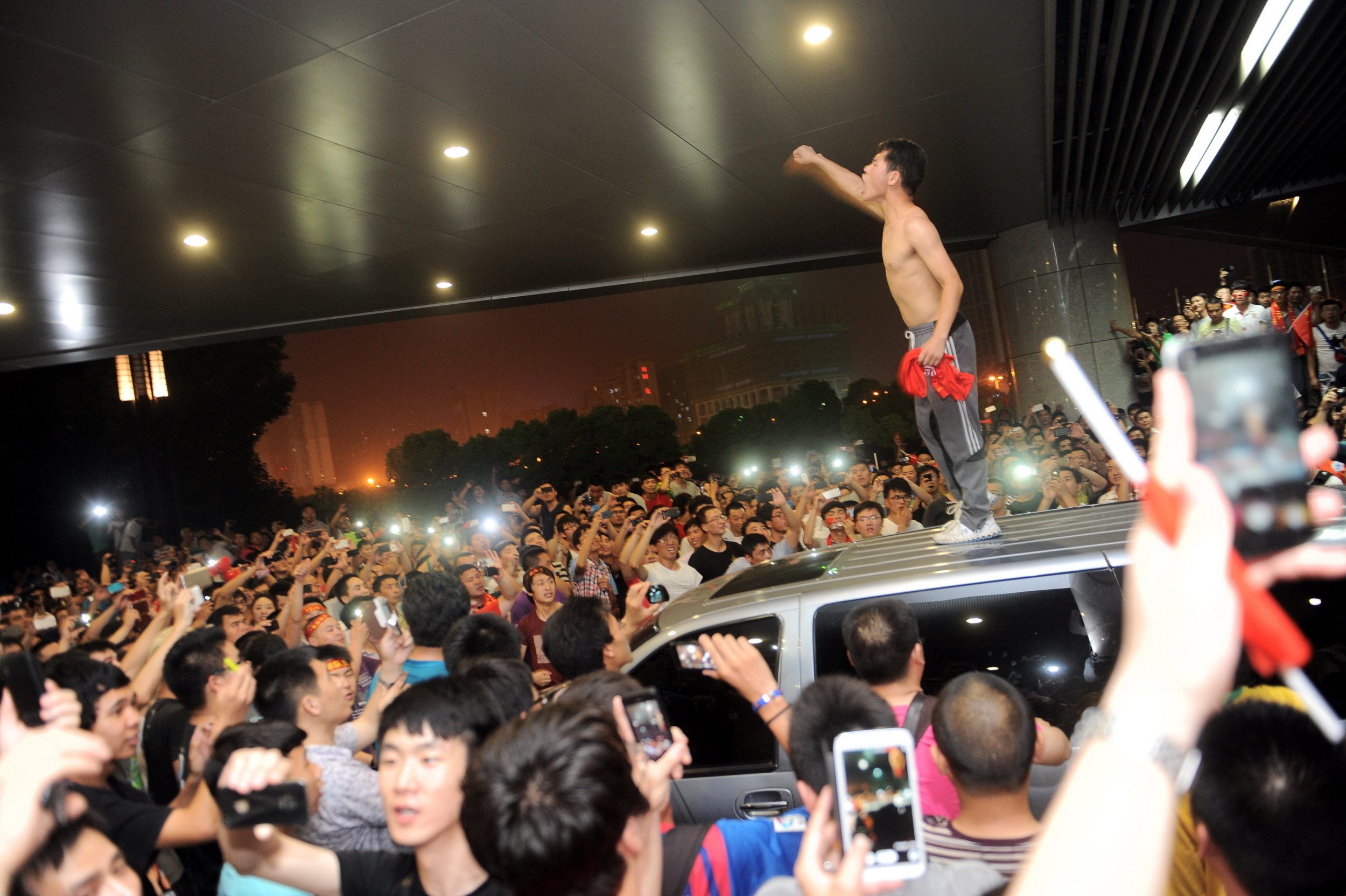An angry fan of the Chinese national football team after China was defeated 5-1 by Thailand, June 15 2013.