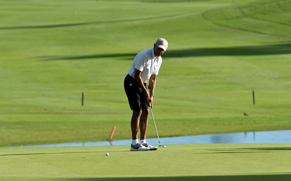 Barack Obama takes an unannounced trip to Hawaii and is spotted golfing with minimal security.