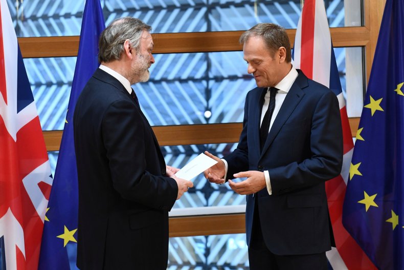 Britain's permanent representative to the European Union Tim Barrow, left, delivers British Prime Minister Theresa May's Brexit letter triggering Article 50 to Donald Tusk, right.