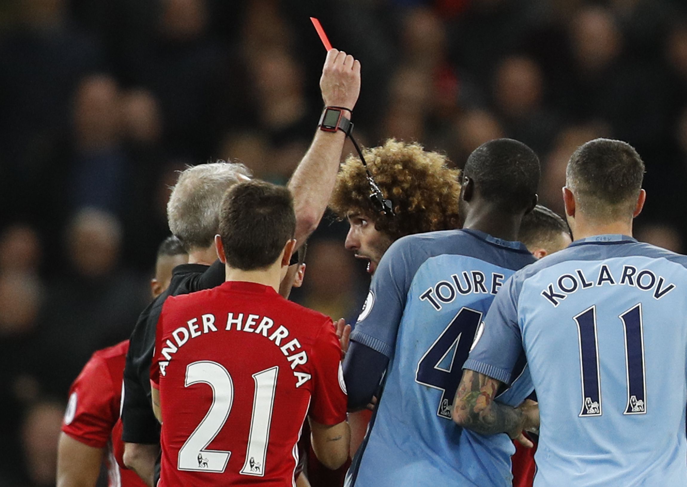 Manchester United's Marouane Fellaini is shown a red card by referee Martin Atkinson at Etihad Stadium, Manchester, April 27. 