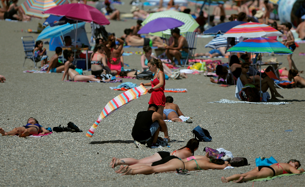 Beach beauties hang out naked below the sun