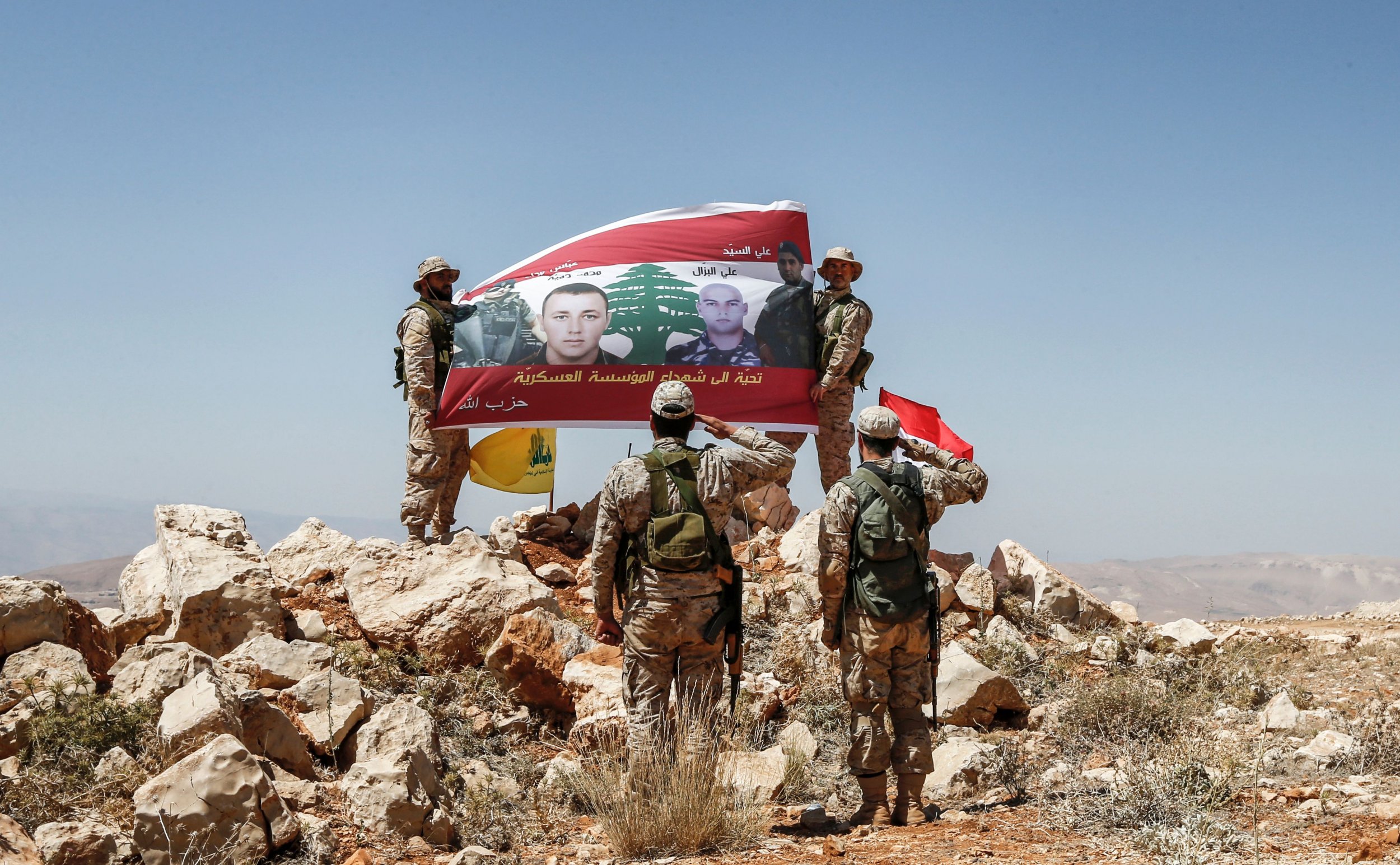 Hezbollah salute a flag