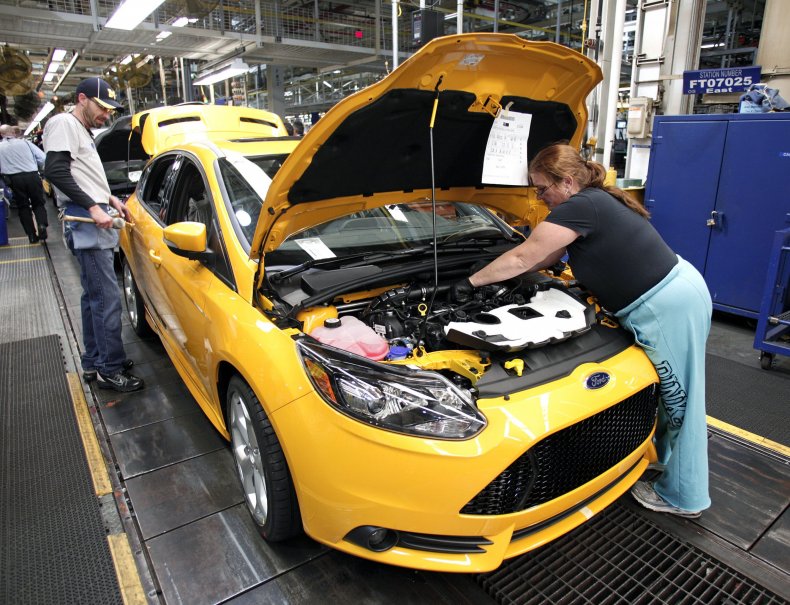 Ford workers on assembly line