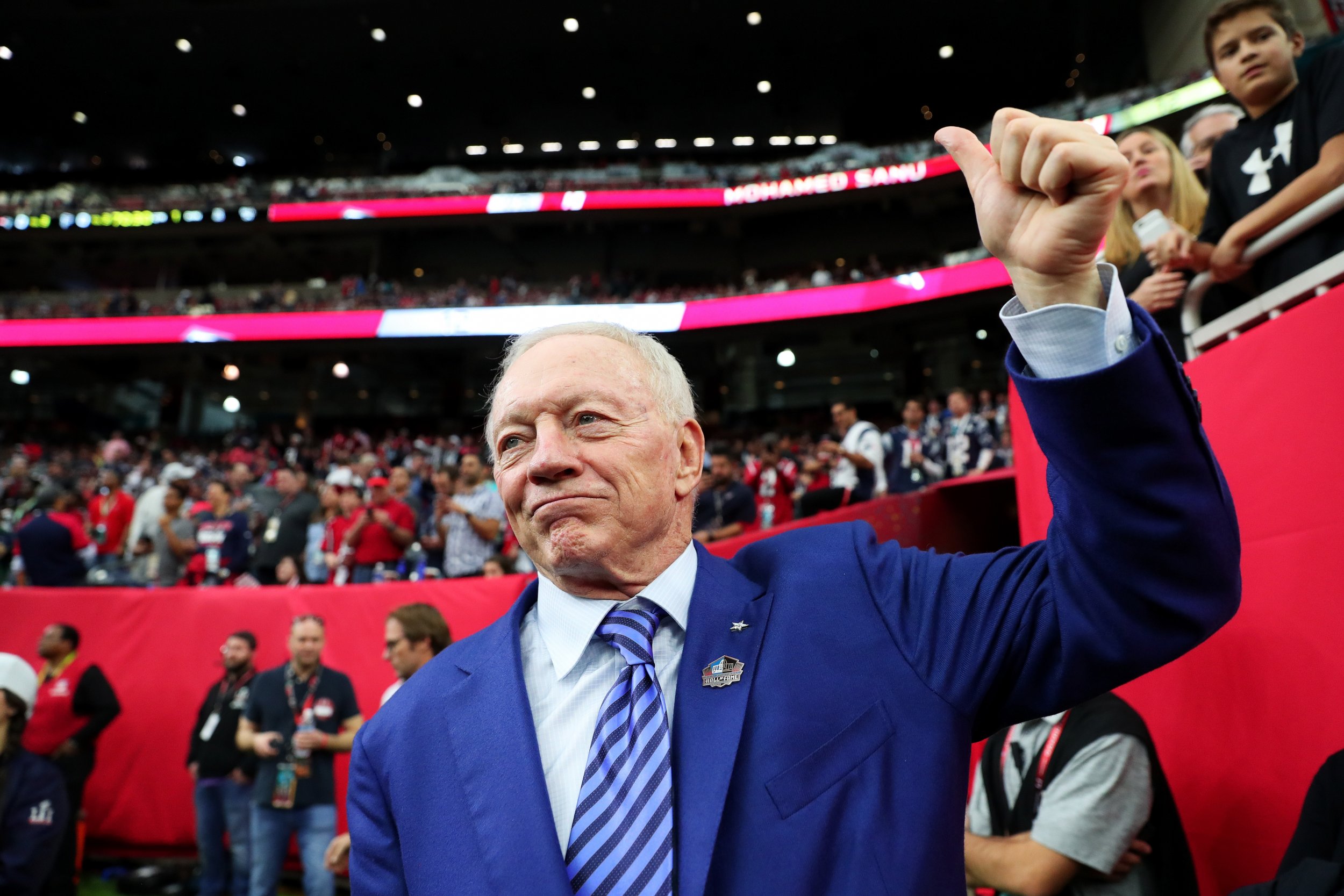 Dallas Cowboys, including owner Jerry Jones, link arms, kneel