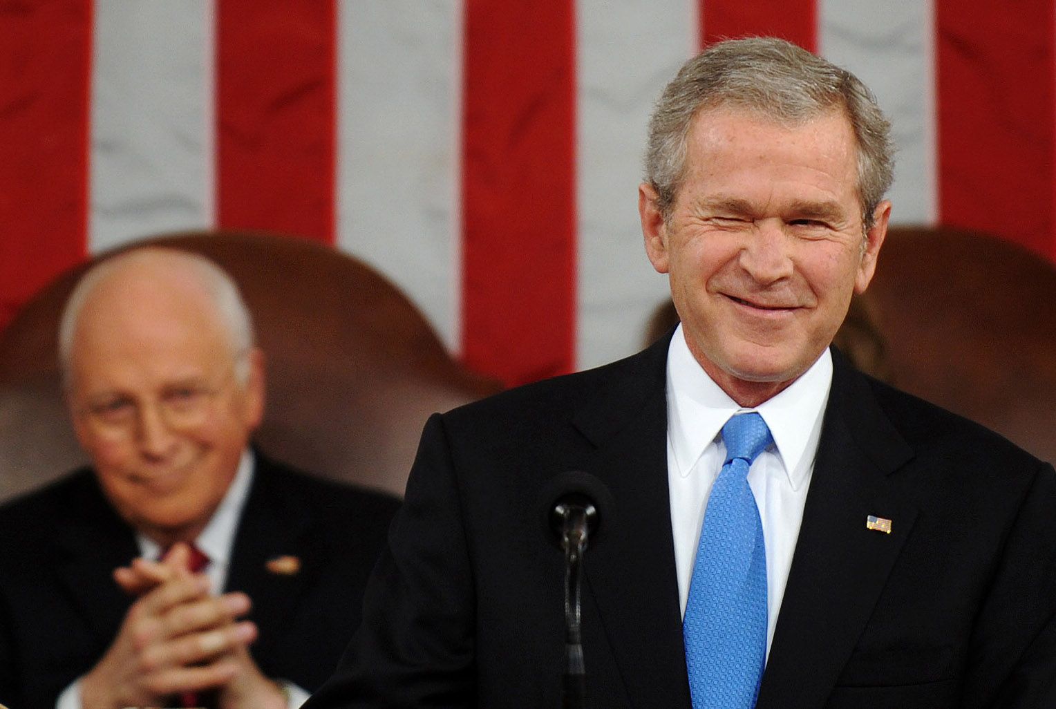 President George W. Bush (C) accepts a football jersey denoting